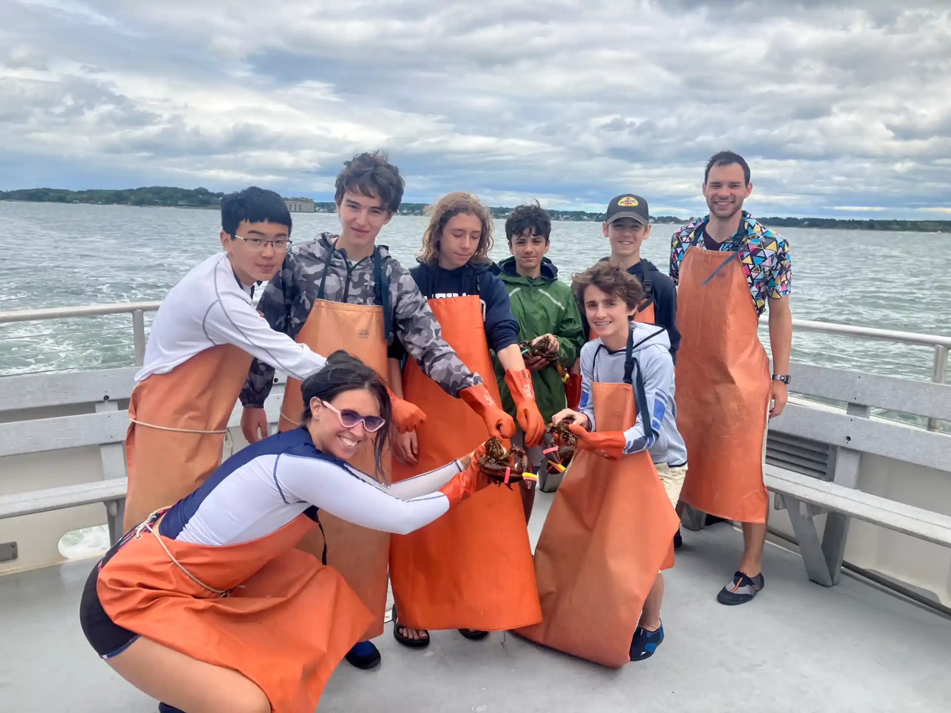 a group of people posing for a photo on a boat