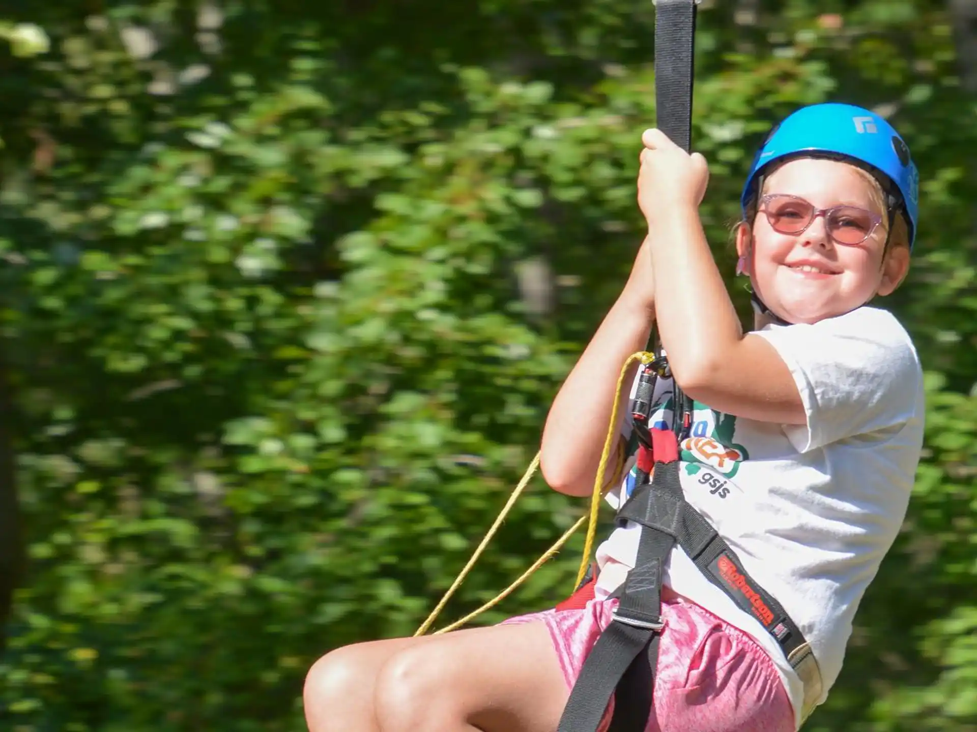 a boy wearing a helmet and holding a bow and arrow