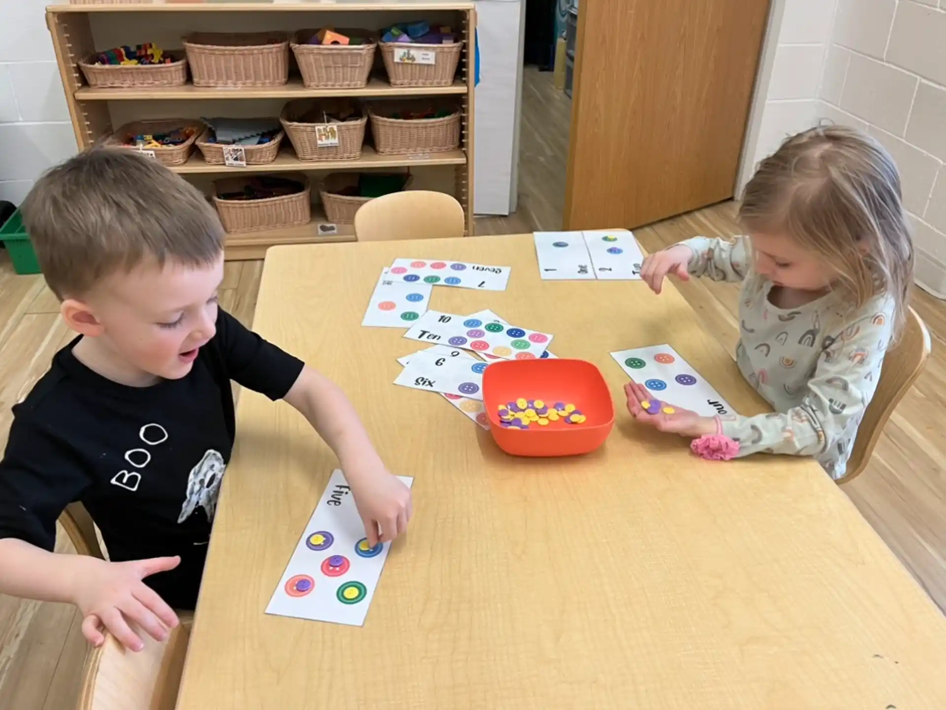 a boy and girl playing with toys