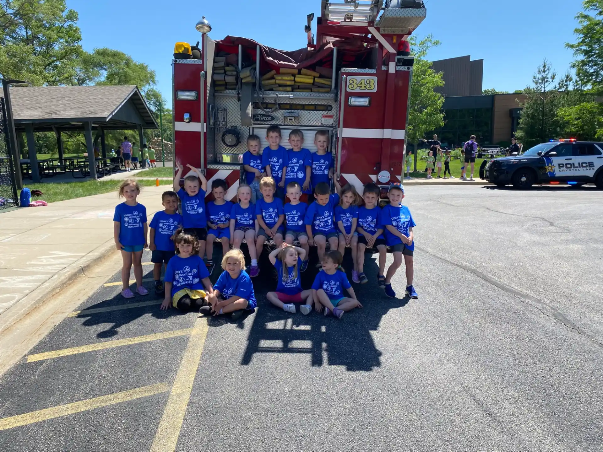 a group of kids posing for a photo in front of a ride