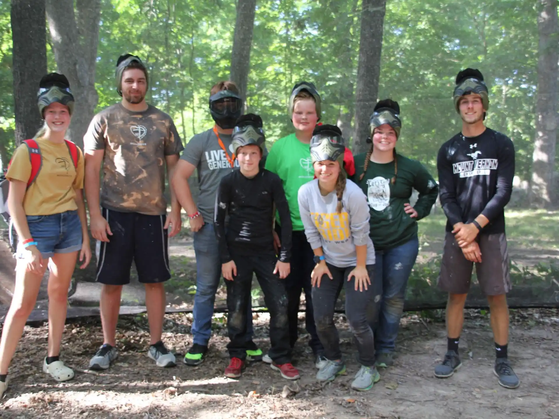 a group of people posing for a photo in the woods