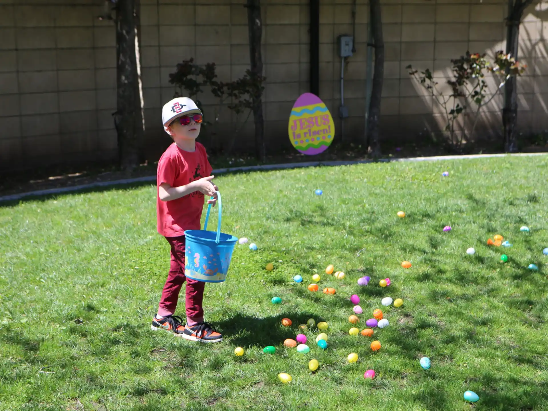 a child holding a bucket of balls