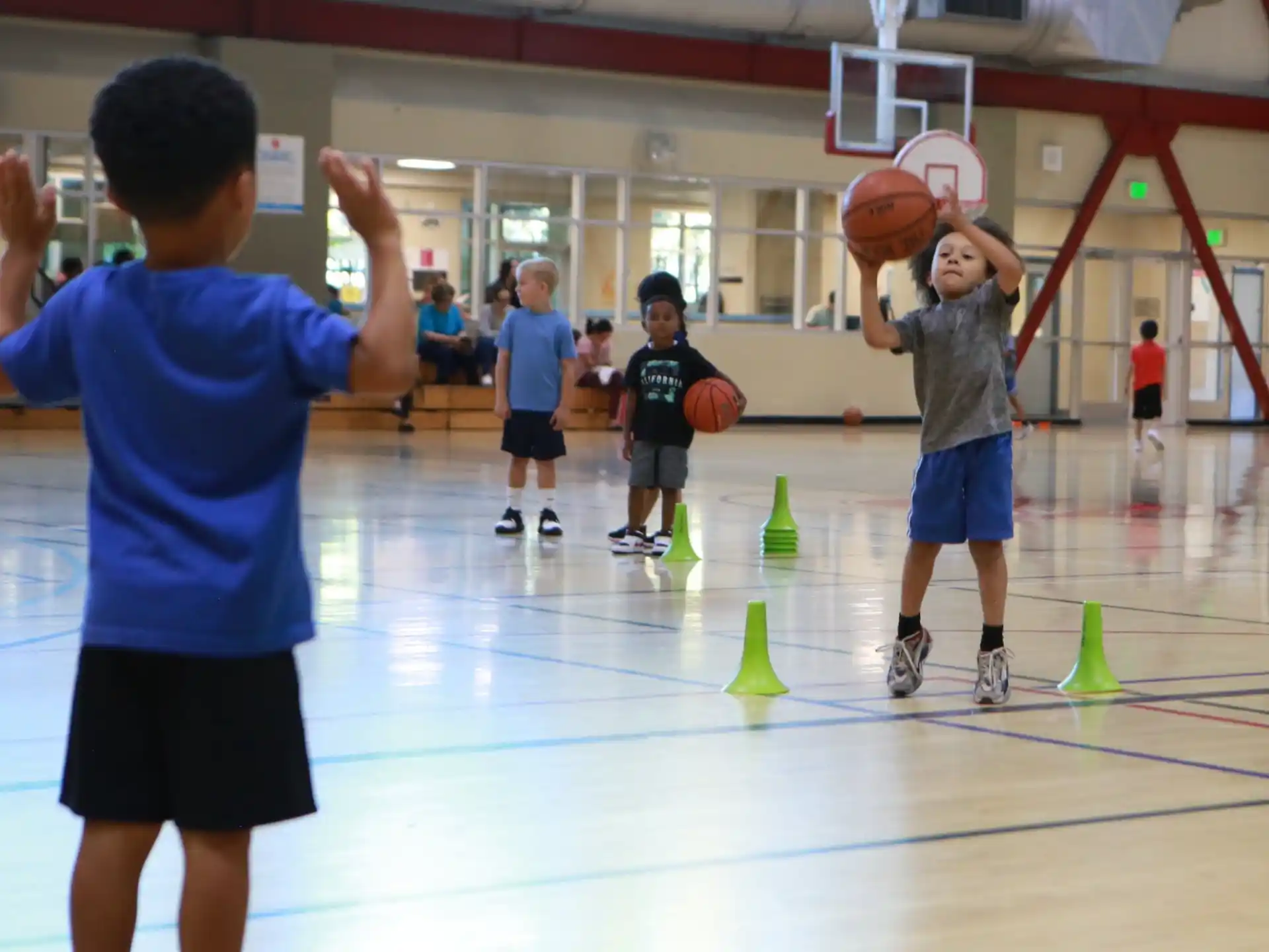 a group of kids playing basketball
