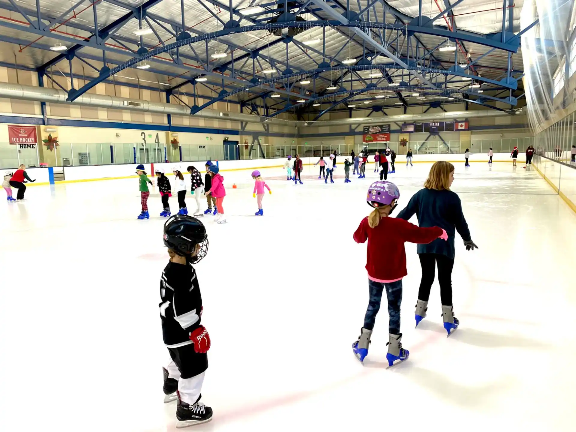 a group of people on an ice rink with an audience