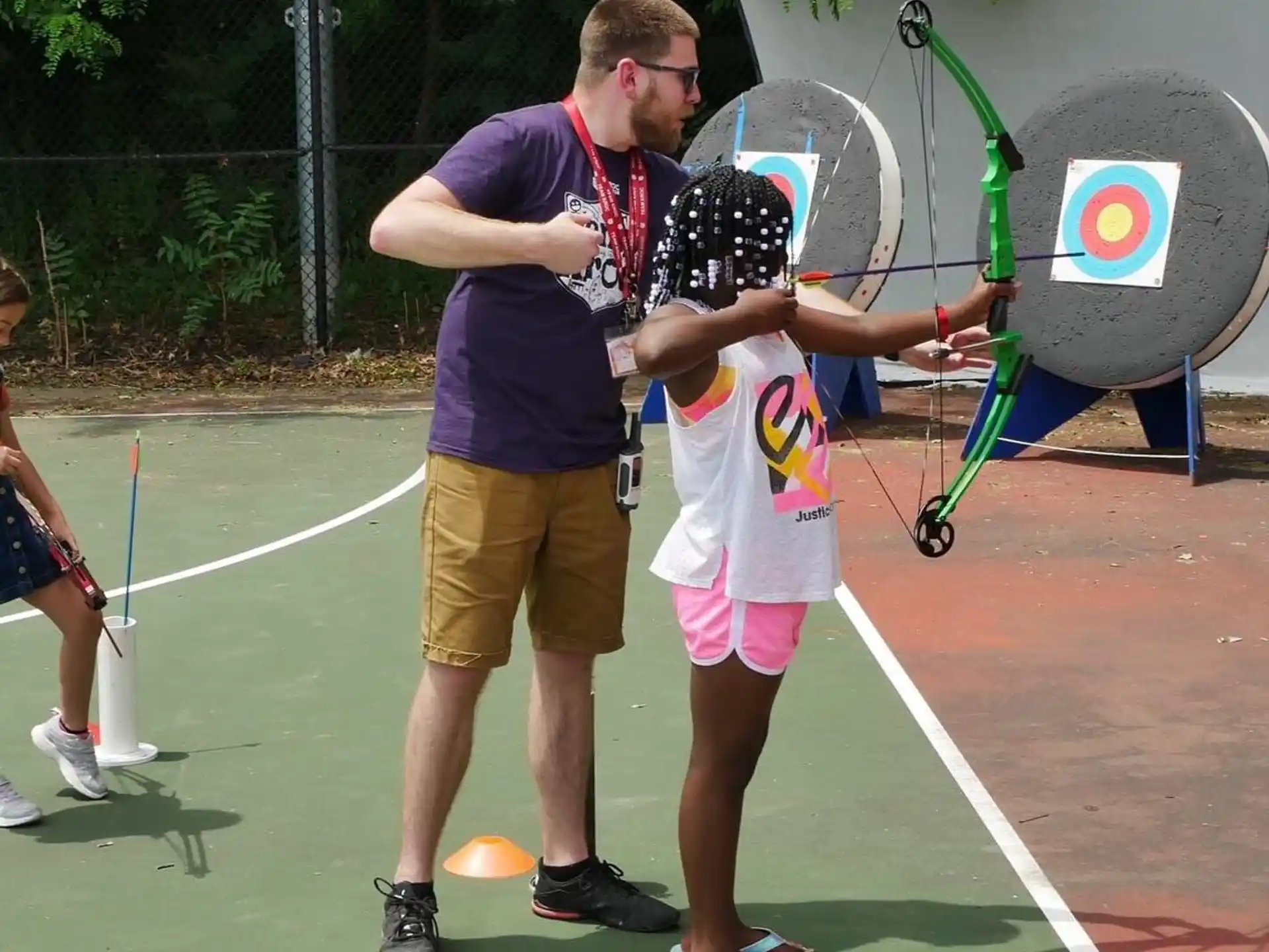 a person and a boy holding tennis rackets