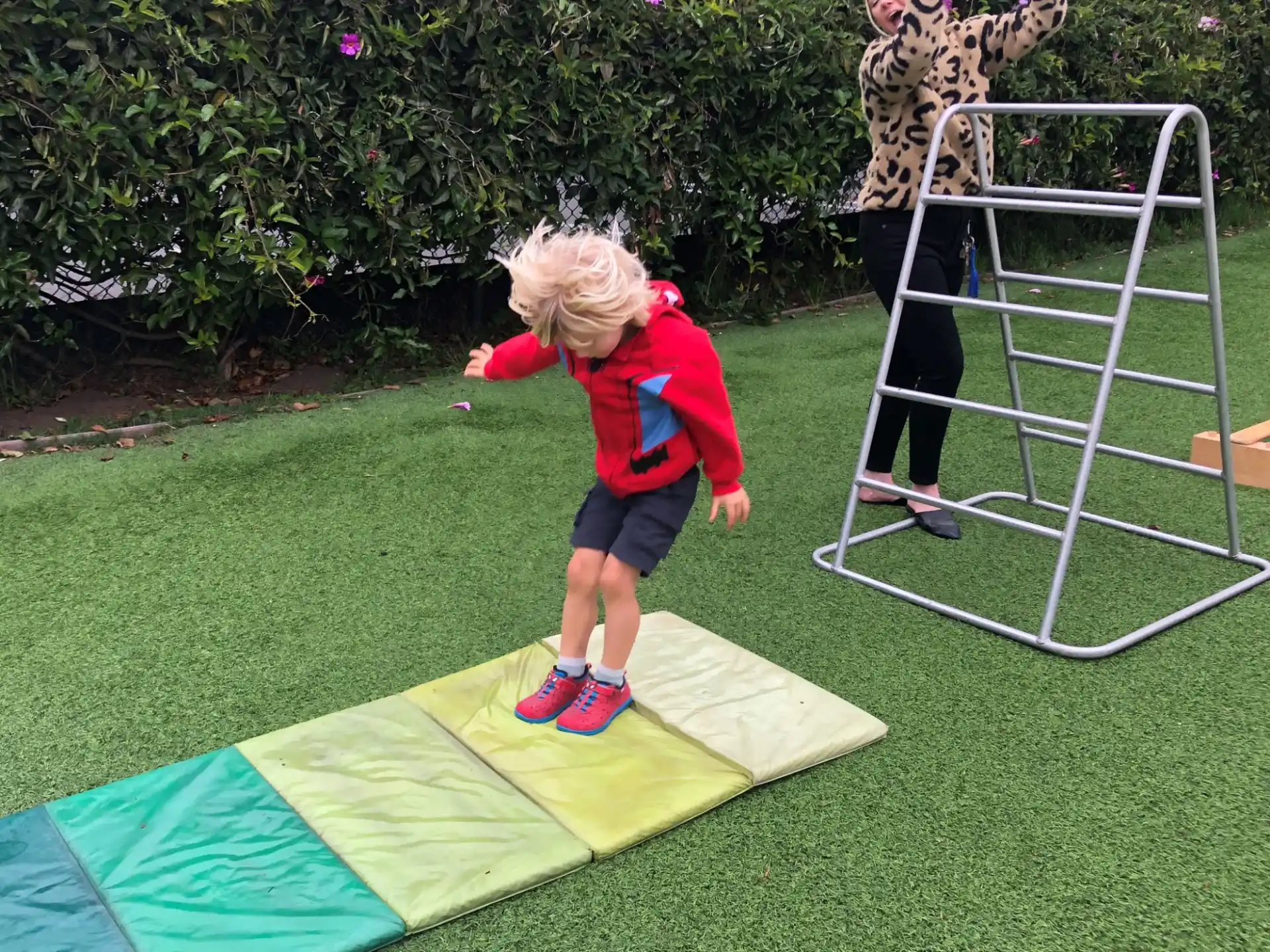 a child standing on a trampoline