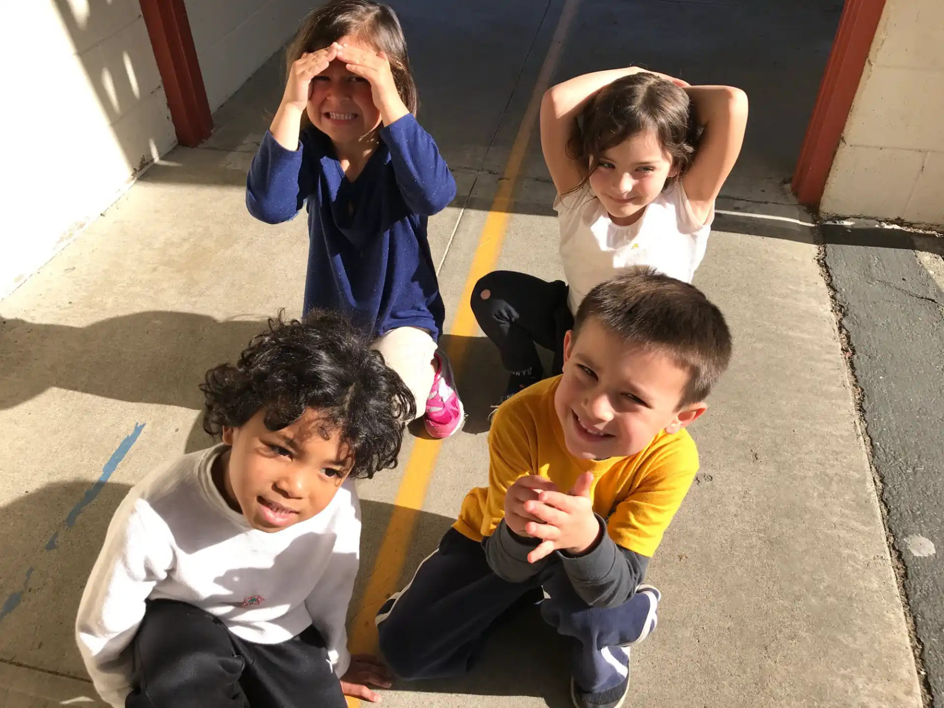 a group of children sitting on the ground