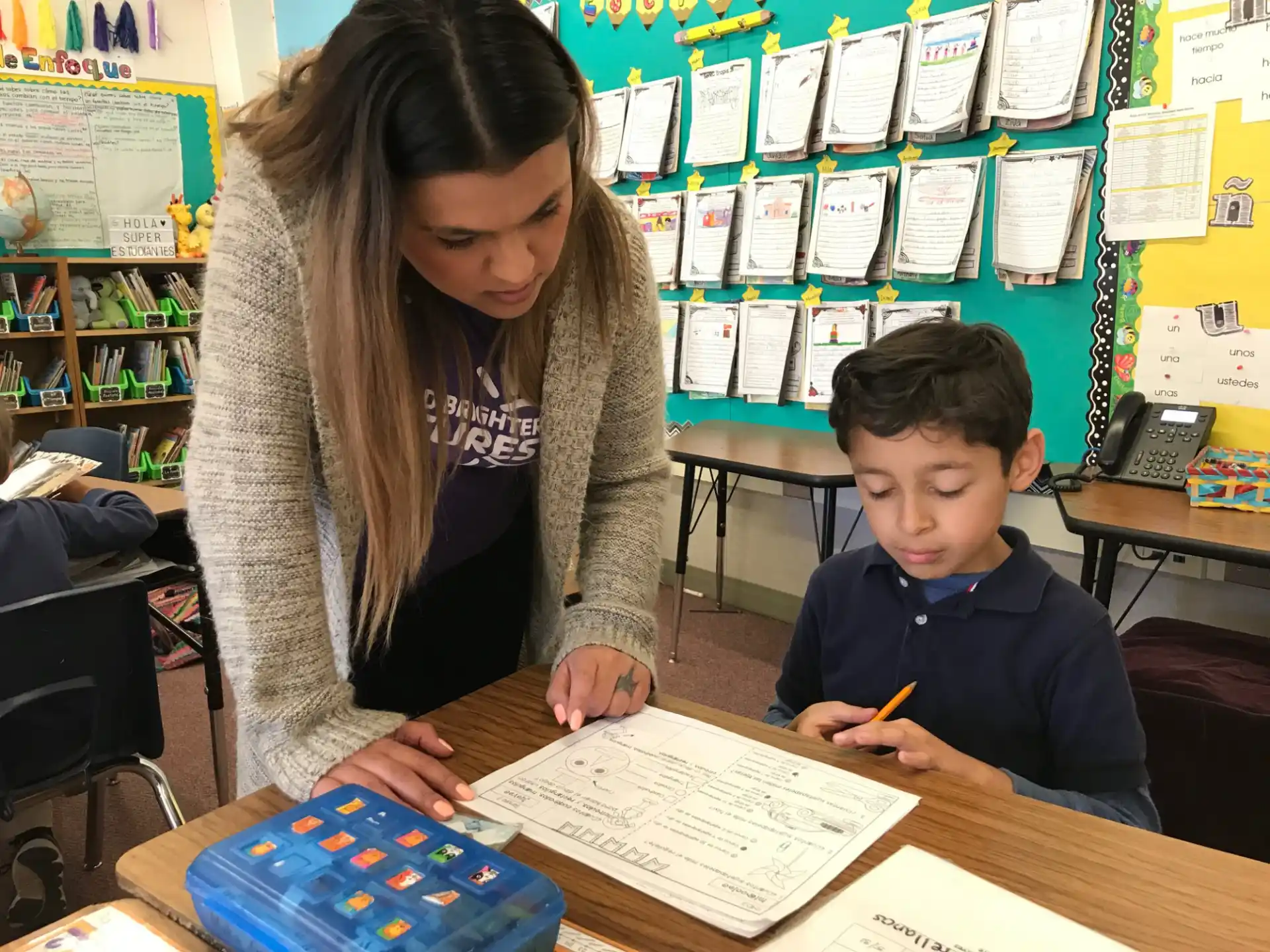 a person and a boy in a classroom
