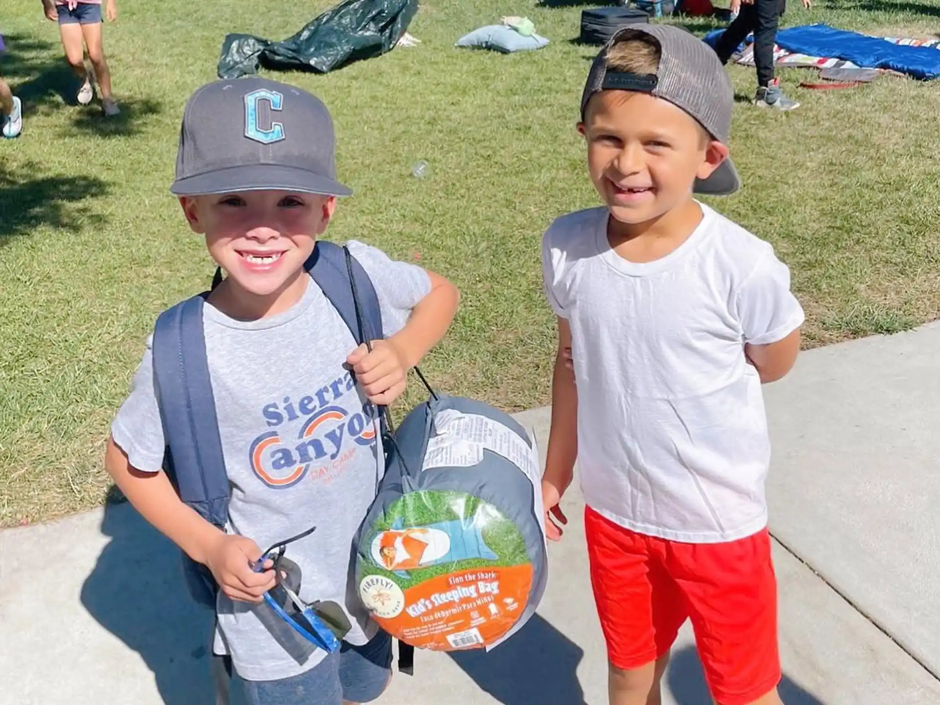 two boys holding skateboards
