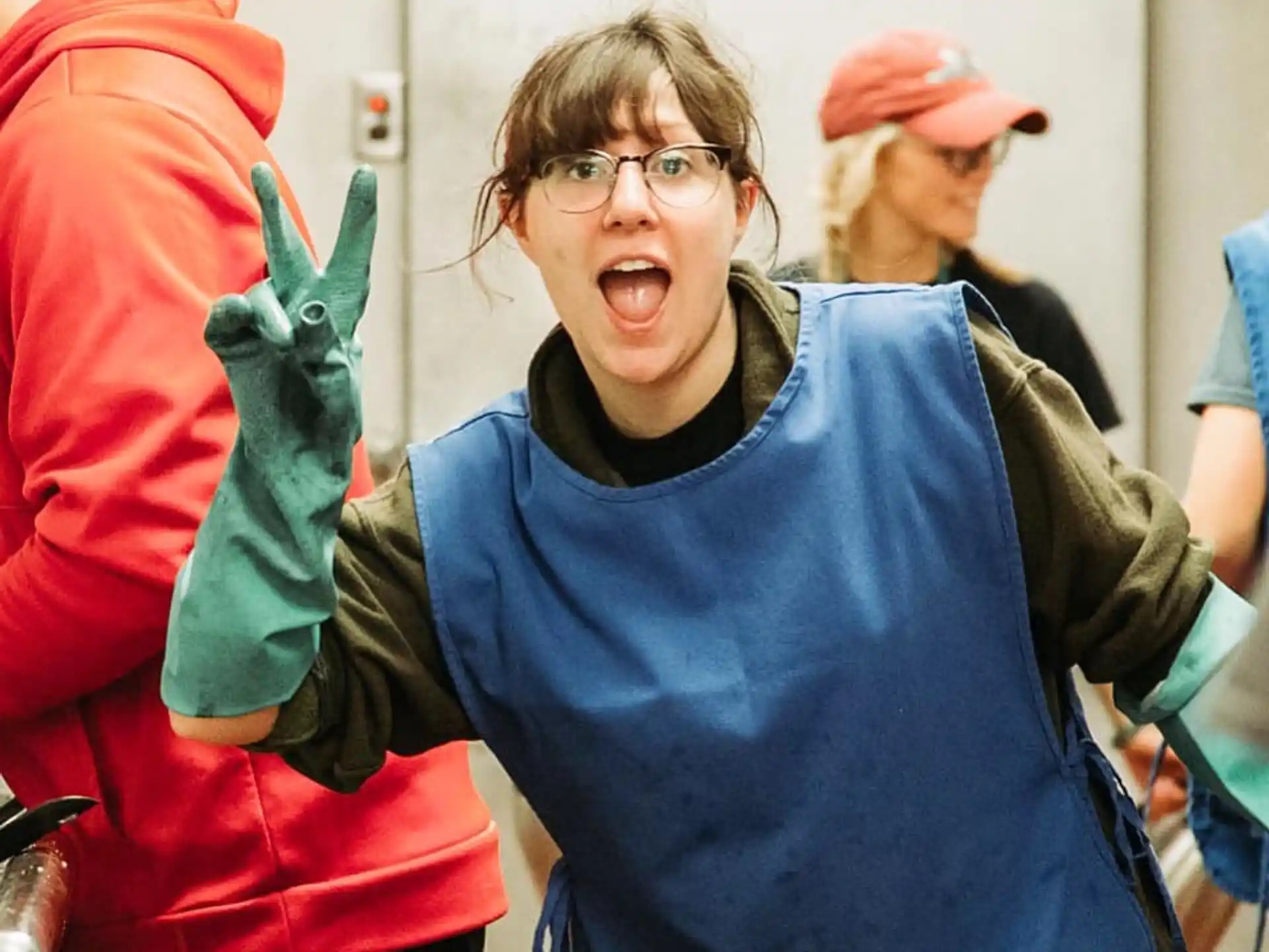 a person with the mouth open and a group of people in the back