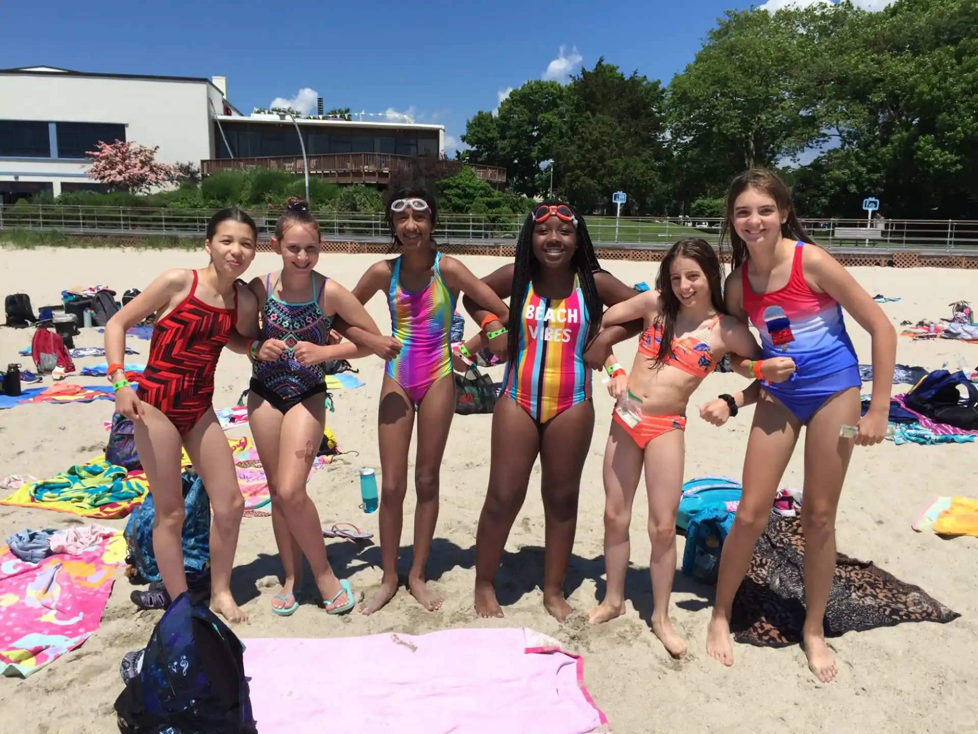 a group of women in garments on a beach