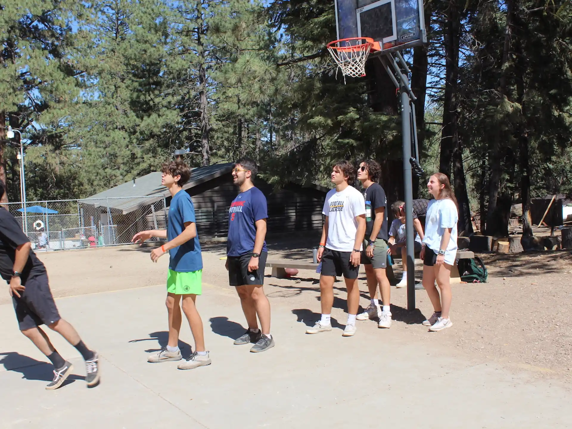 a group of people playing basketball