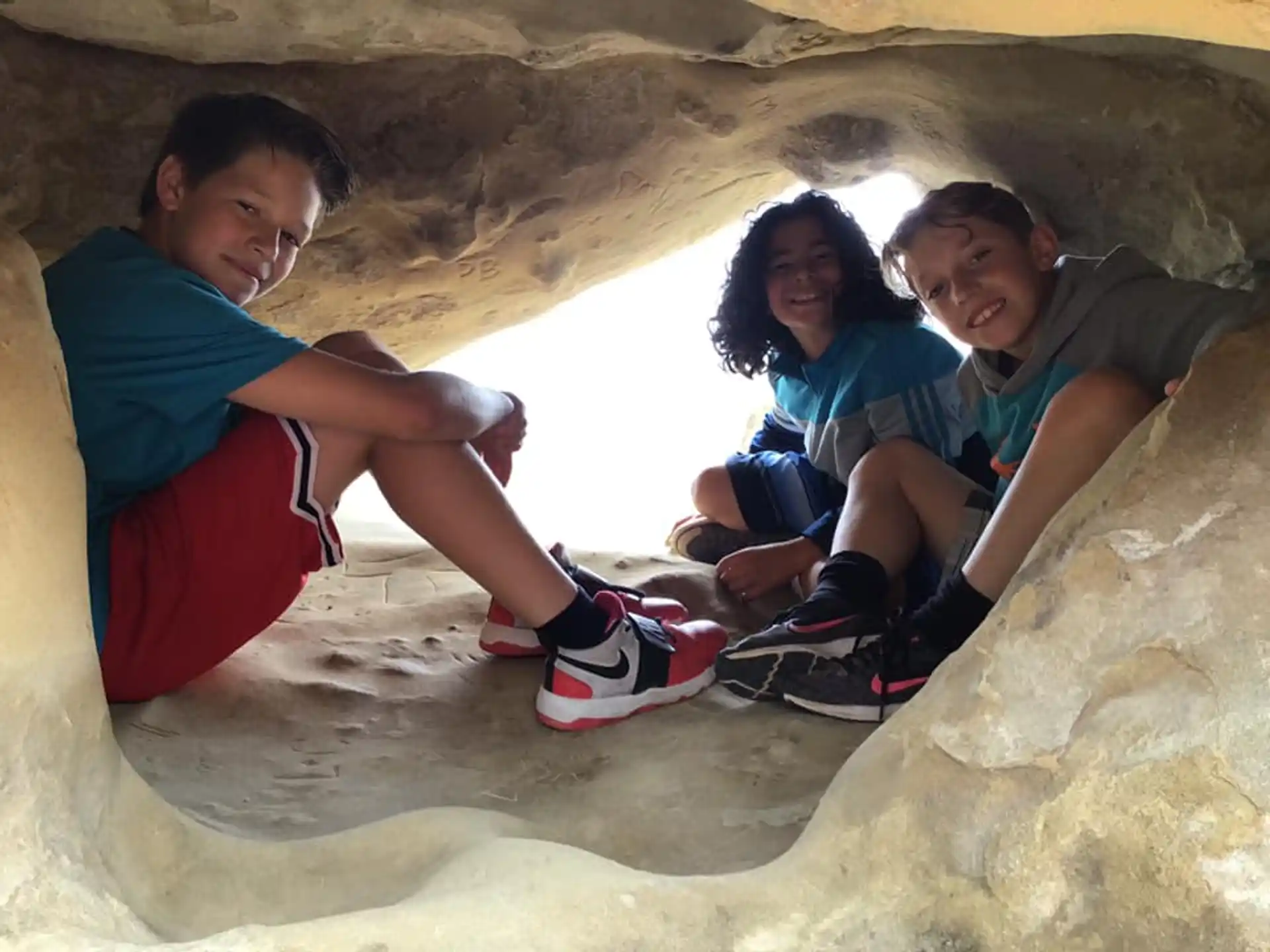 a group of people sitting in a cave
