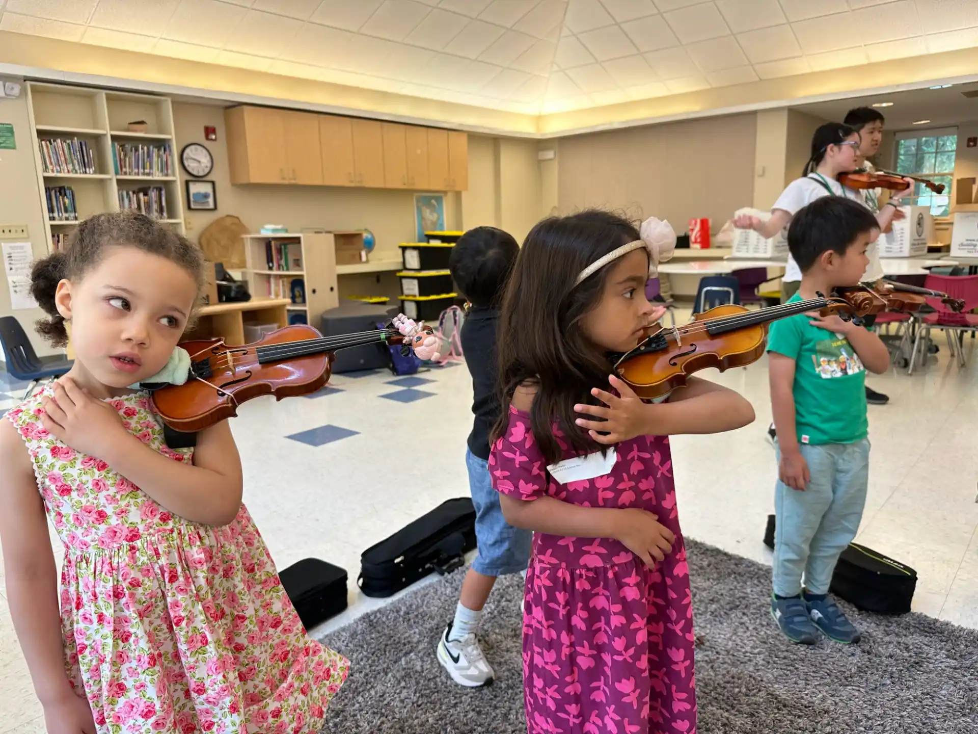 a group of children playing violin