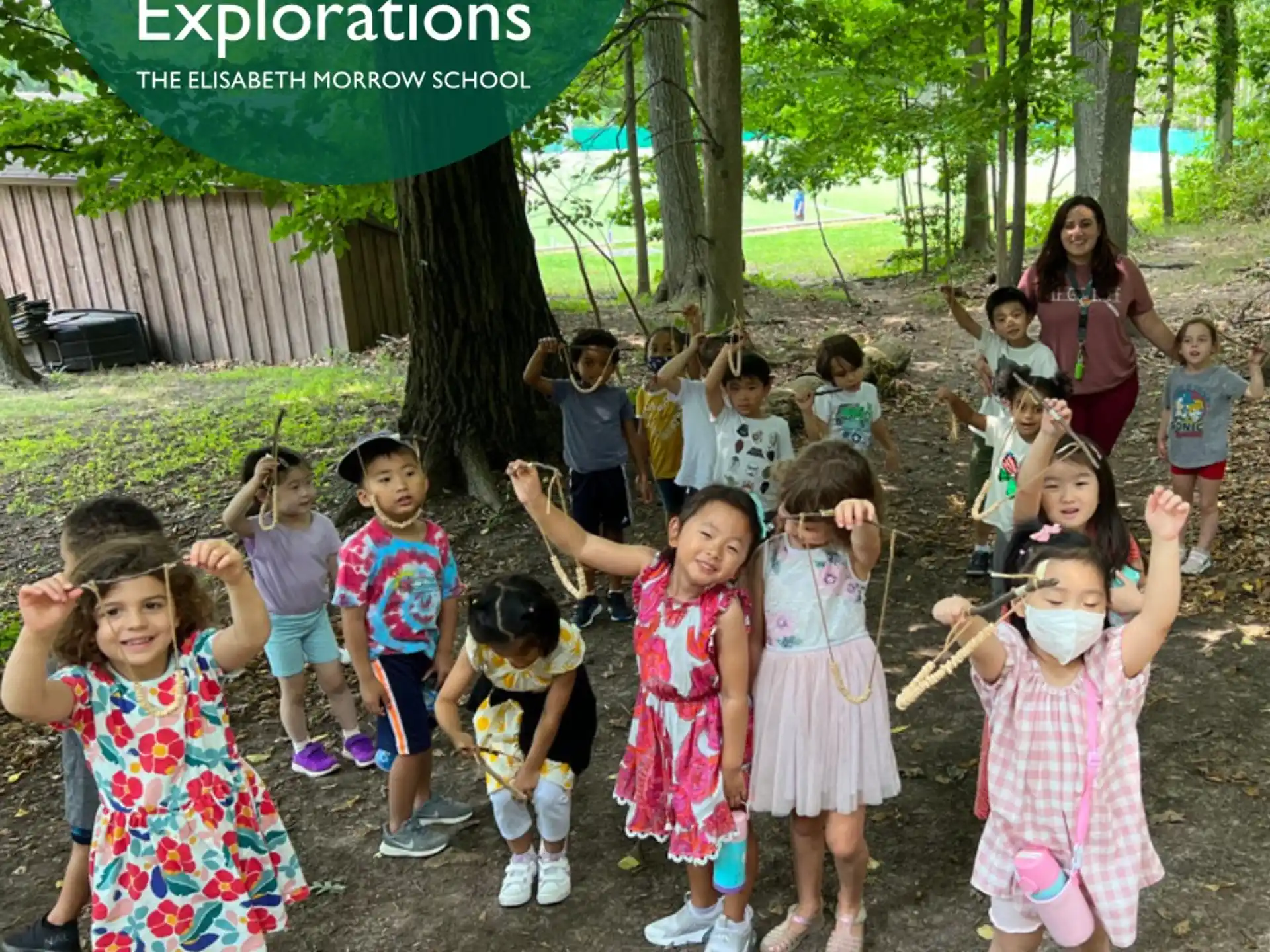 a group of children posing for a photo under a sign
