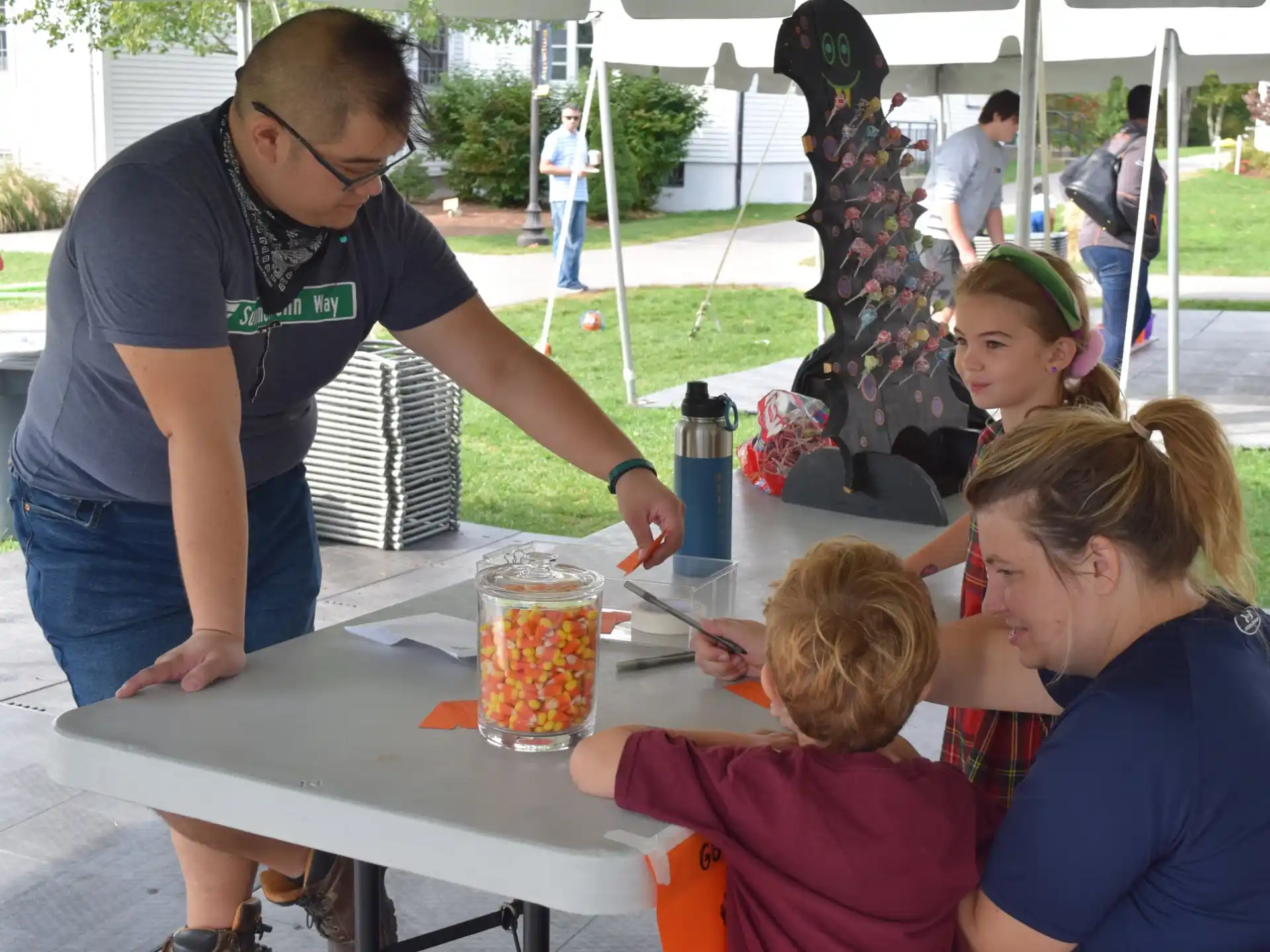 a person painting a table with children