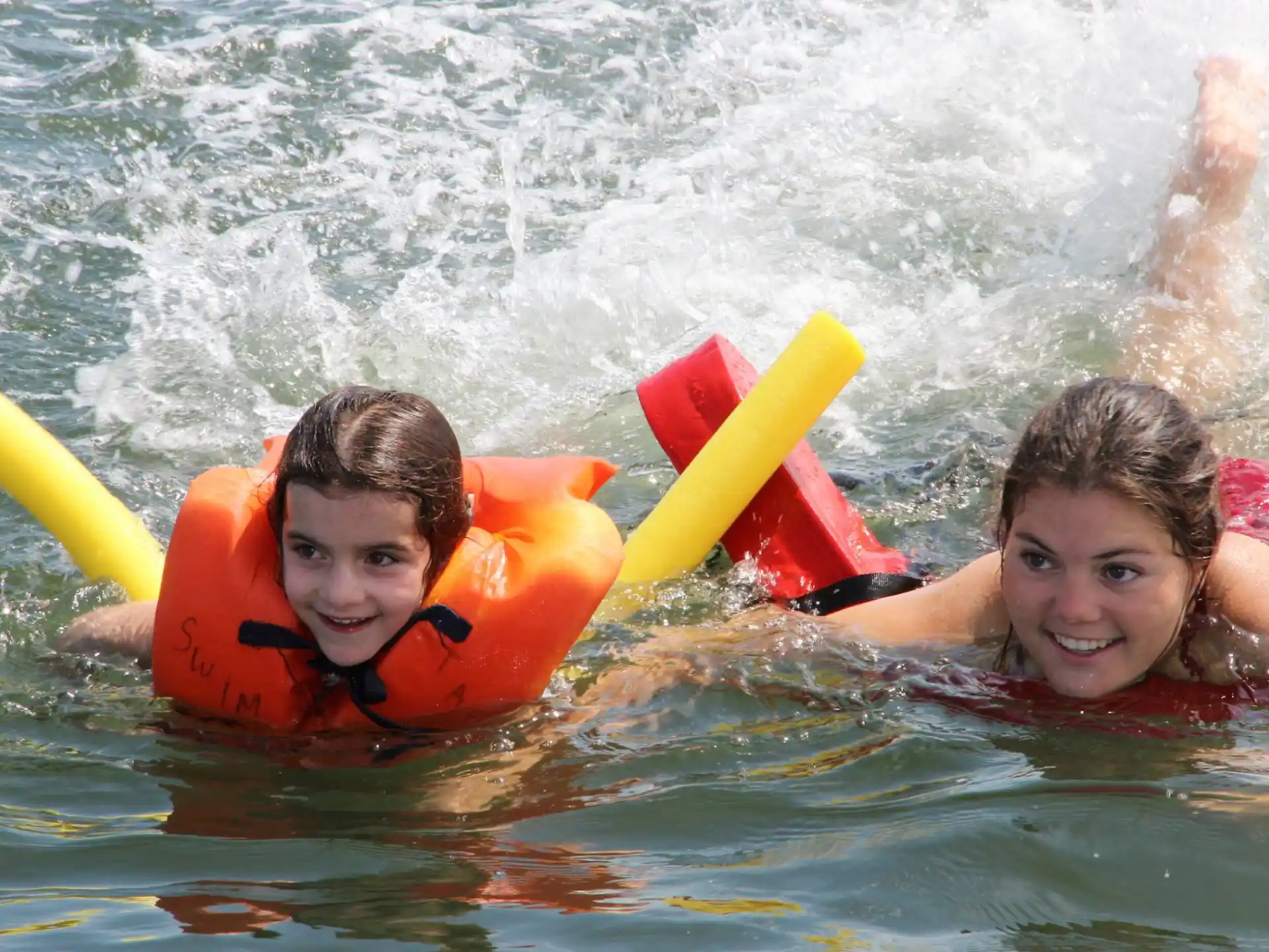 a couple of kids in a pool
