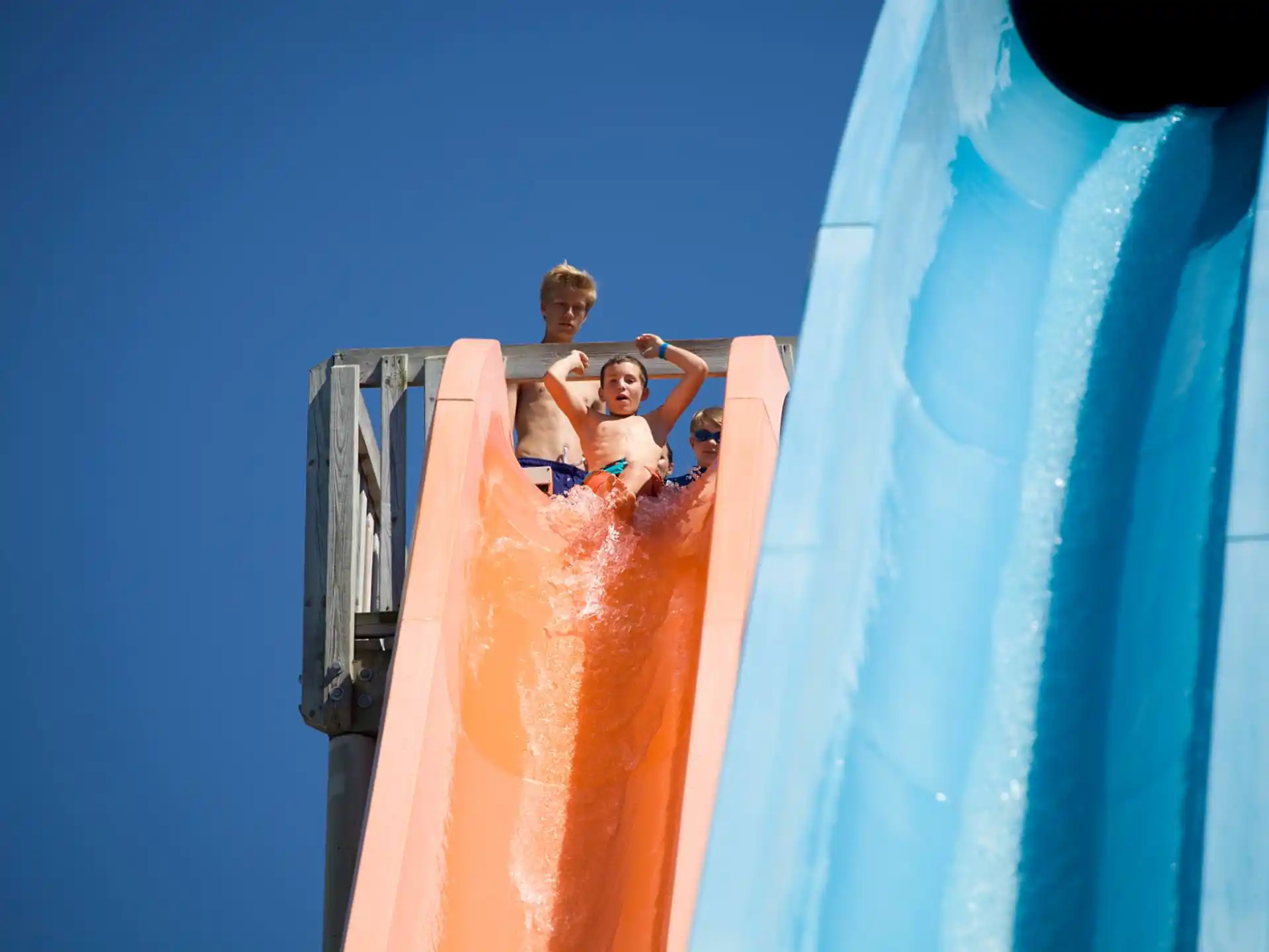 two kids on a water slide