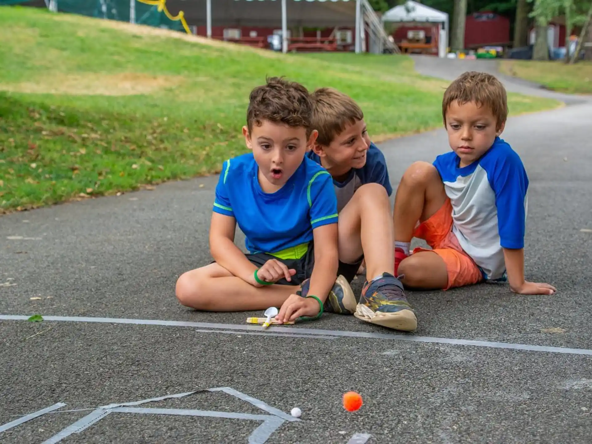 a group of boys sitting on the ground