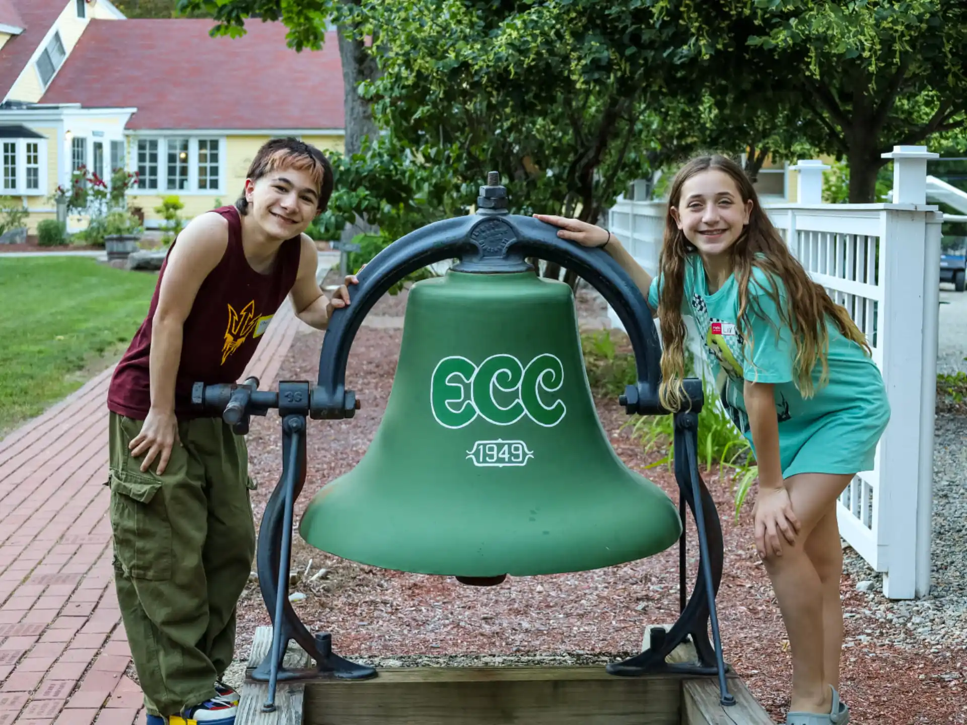 a man and a woman standing next to a green machine