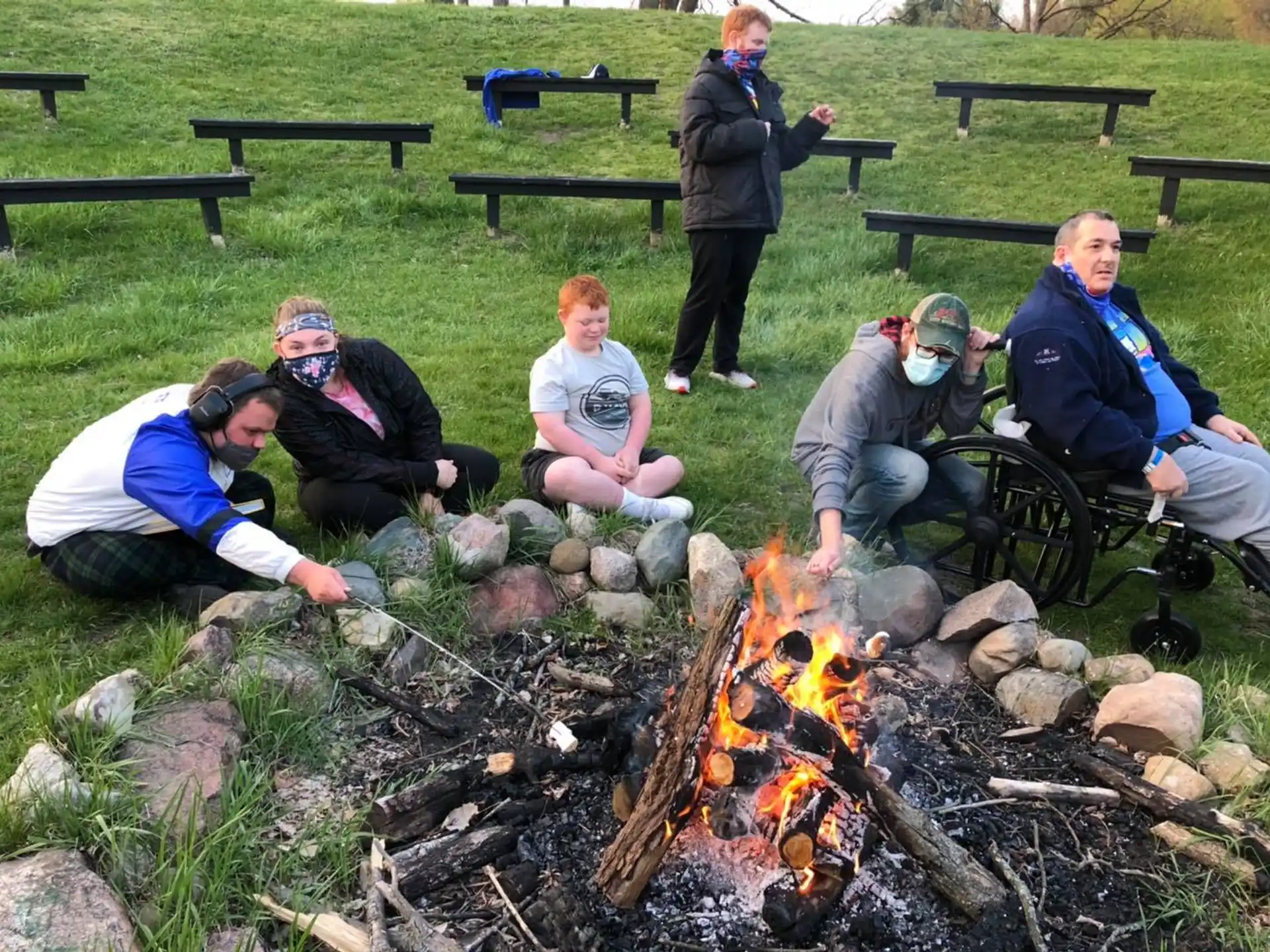 a group of people around a fire