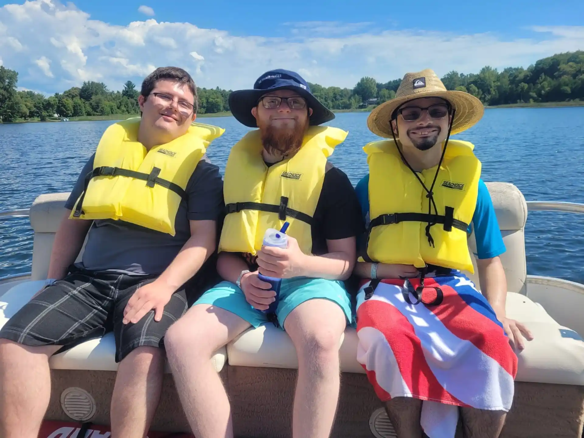 a group of people in life jackets on a boat