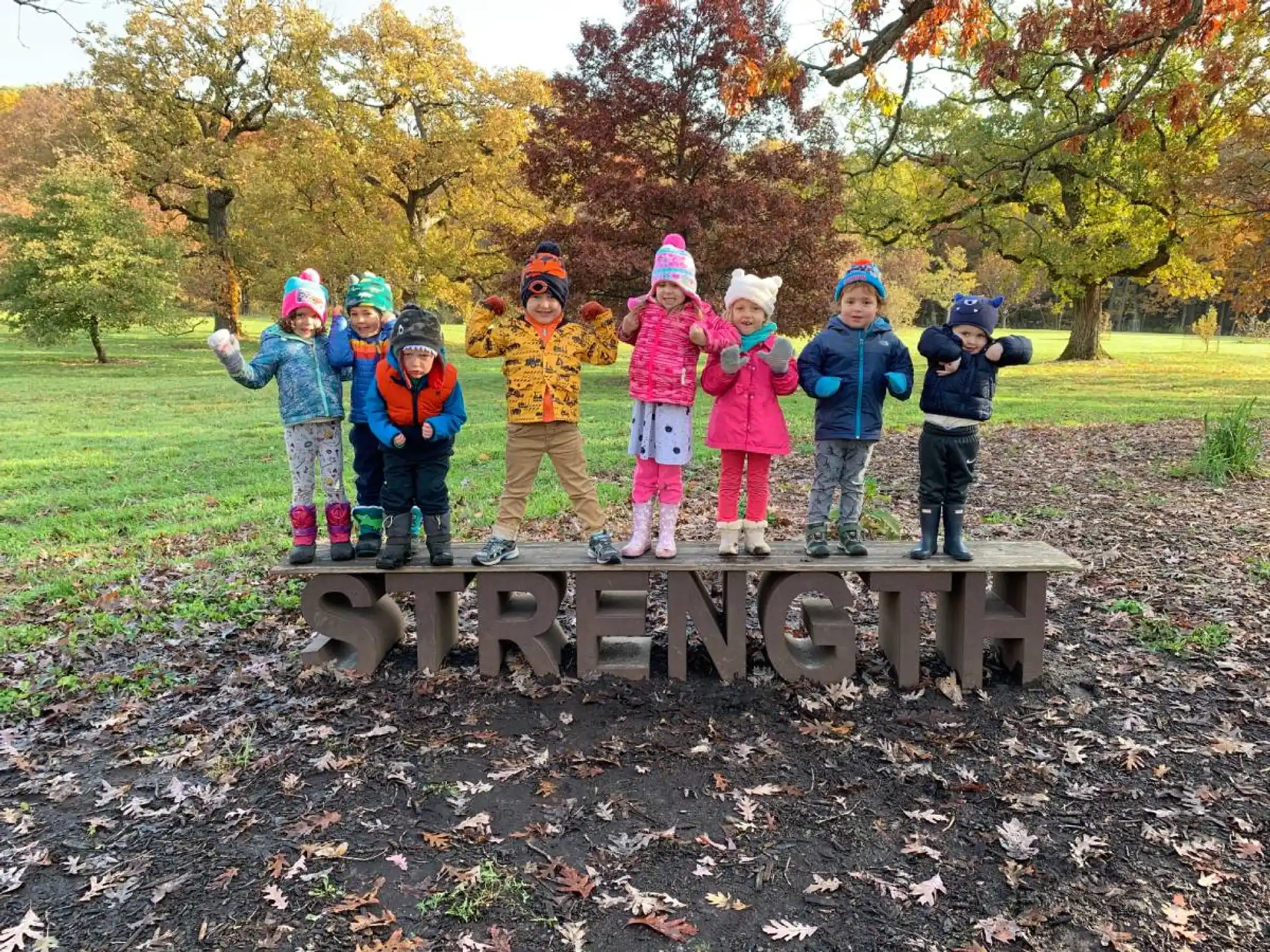 a group of children standing on a cannon in a park