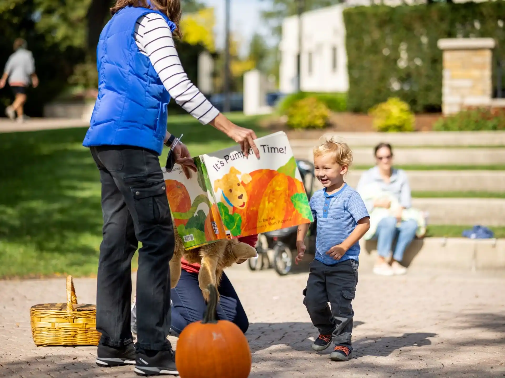 a woman and a child with pumpkins