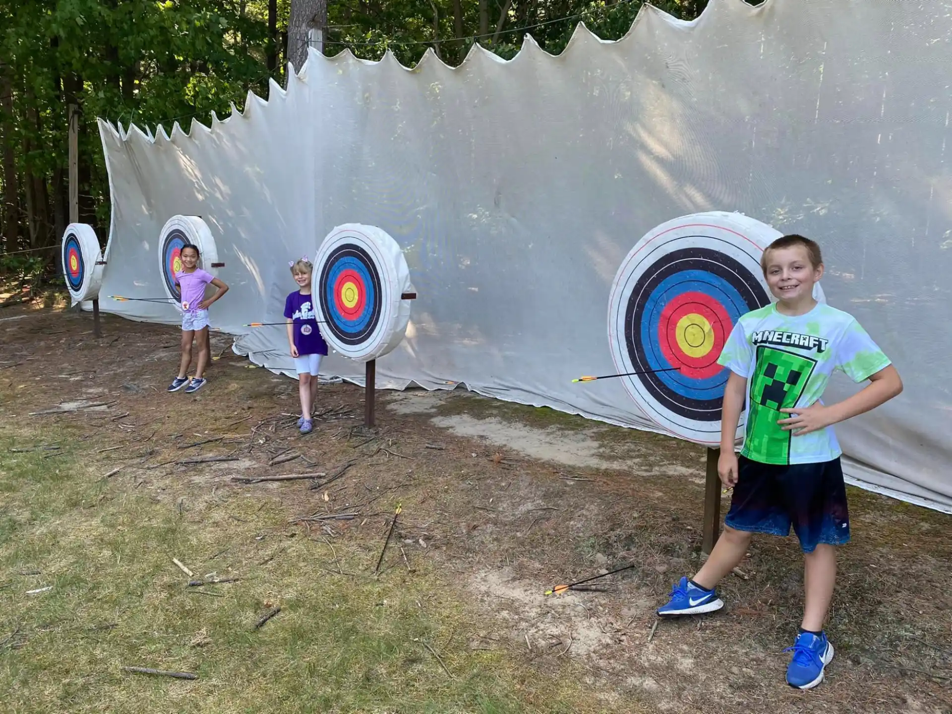 a group of kids standing outside a tent