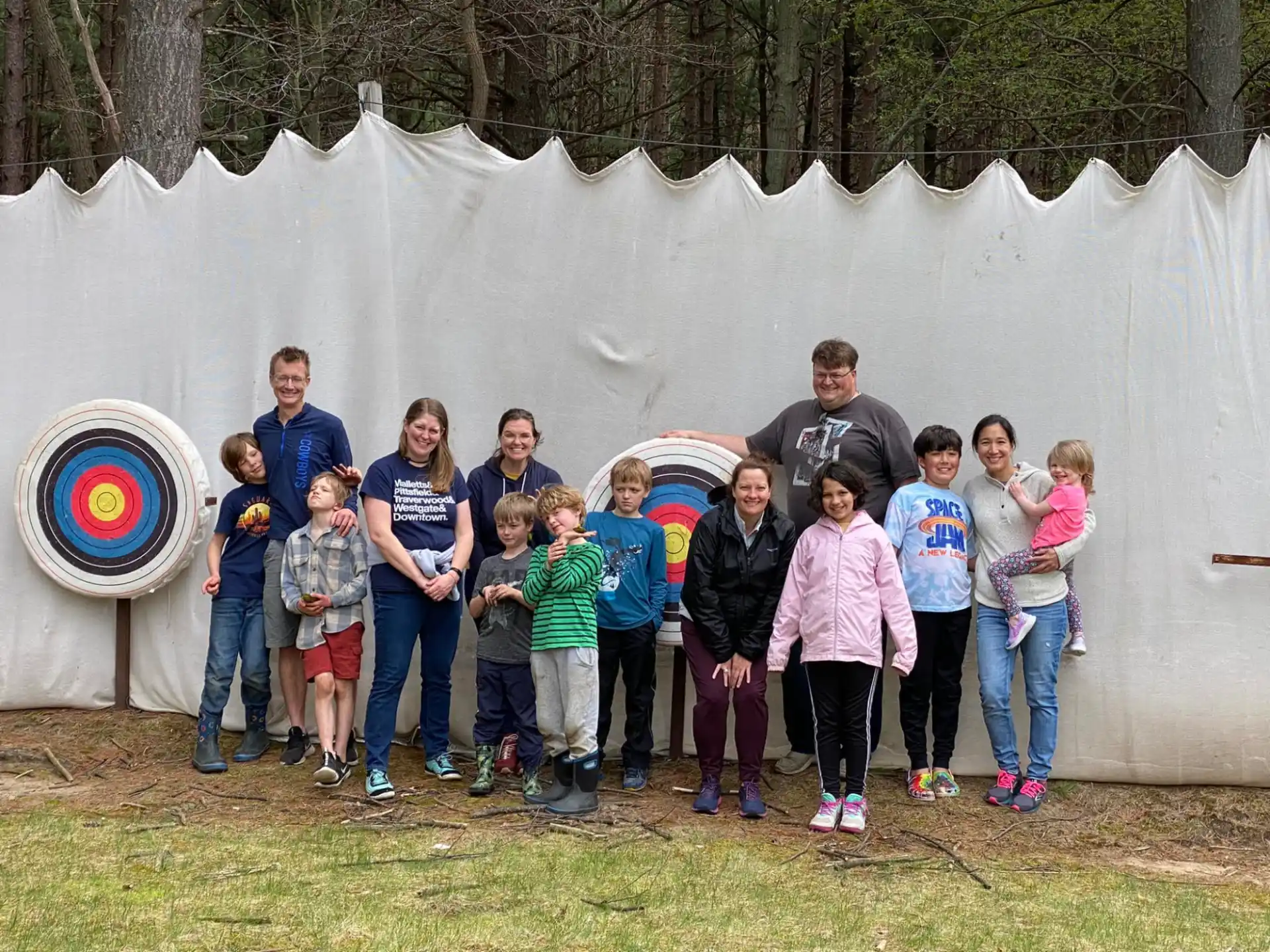 a group of people posing for a photo in front of a white tent