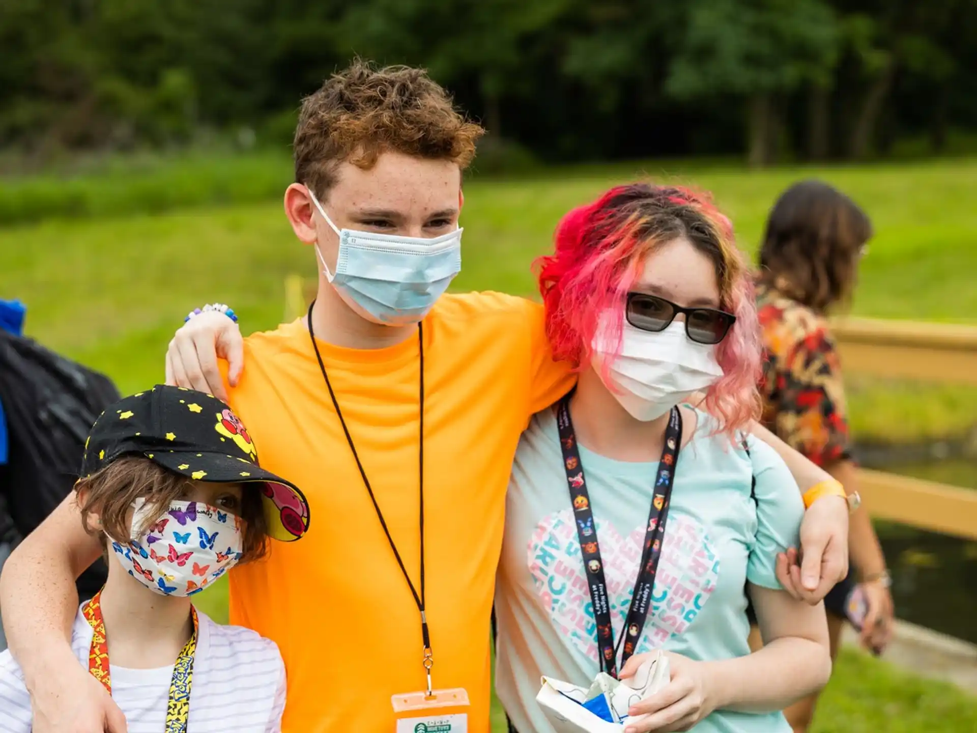 a man with a face mask and a woman with a child