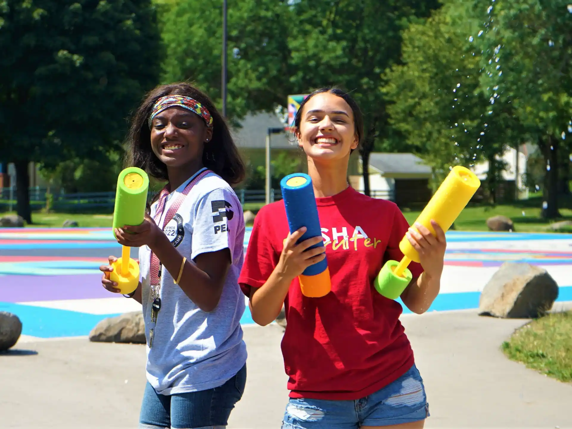 a couple of girls holding yellow toys