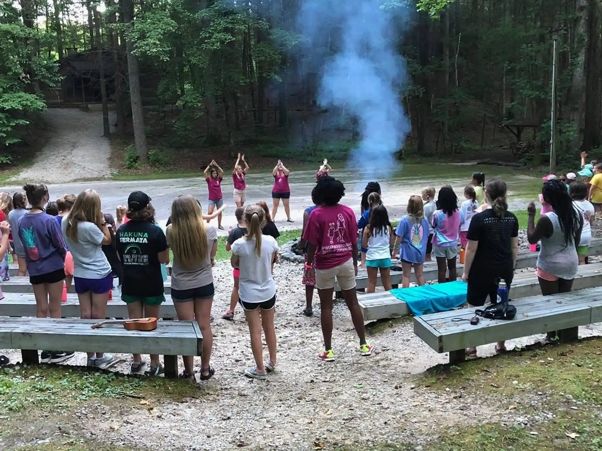a group of people standing around a water fountain