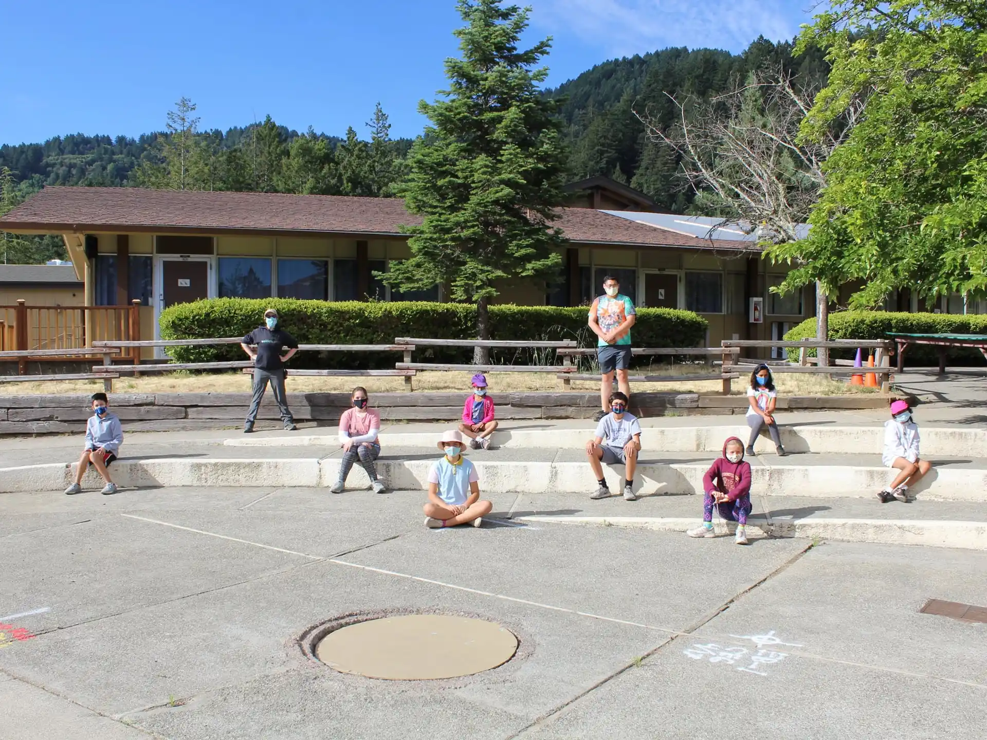a group of people sitting on concrete steps in front of a building