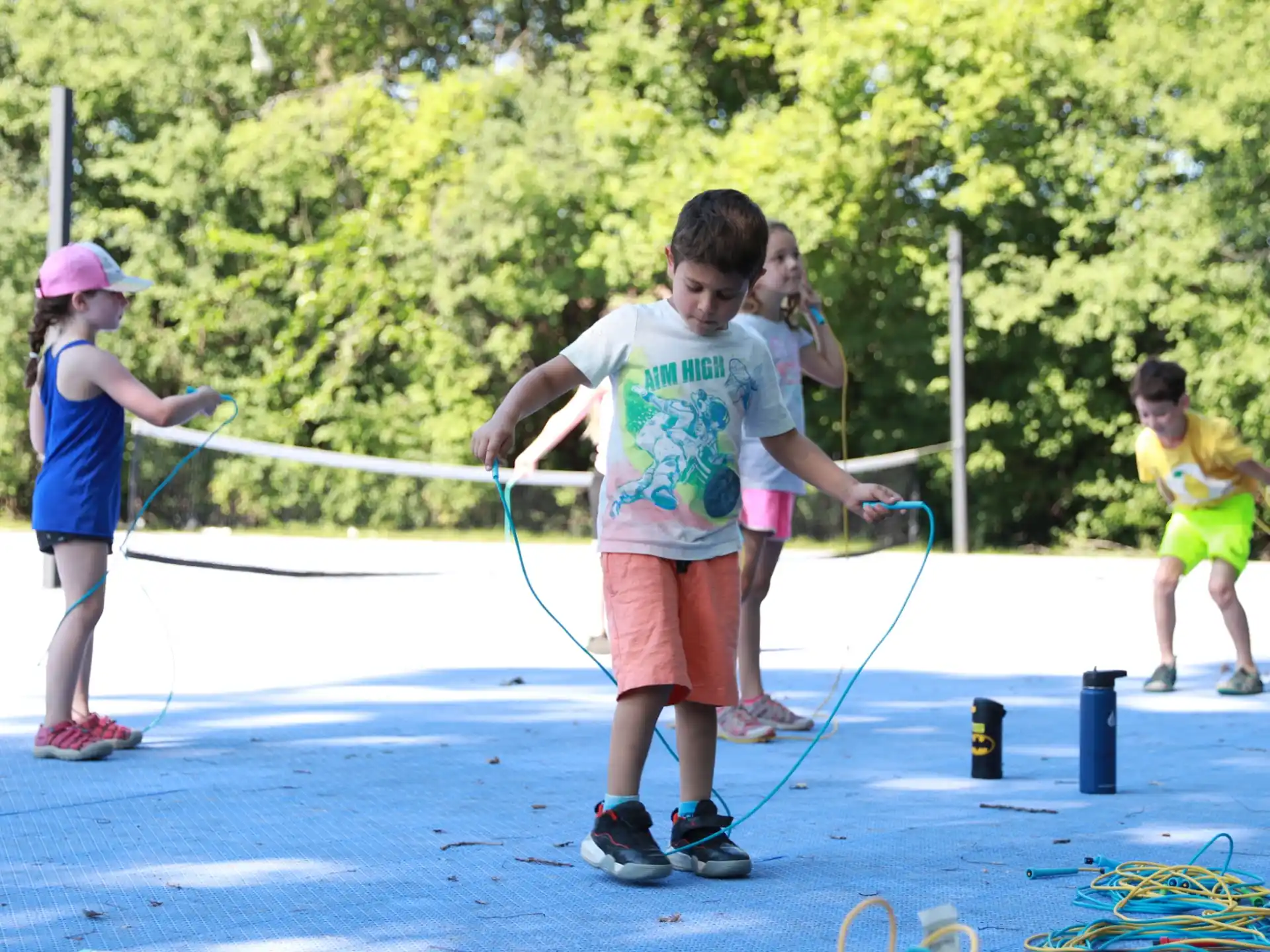 a group of kids playing with bows and arrows