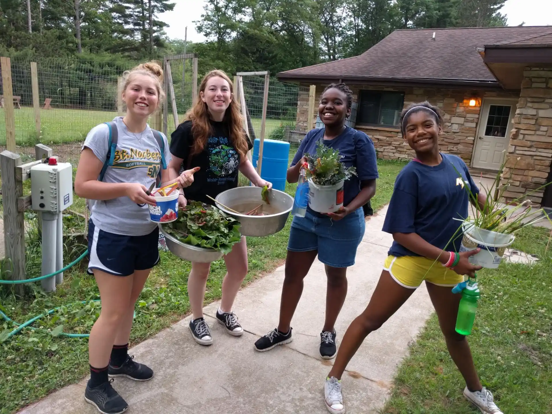 a group of people holding buckets
