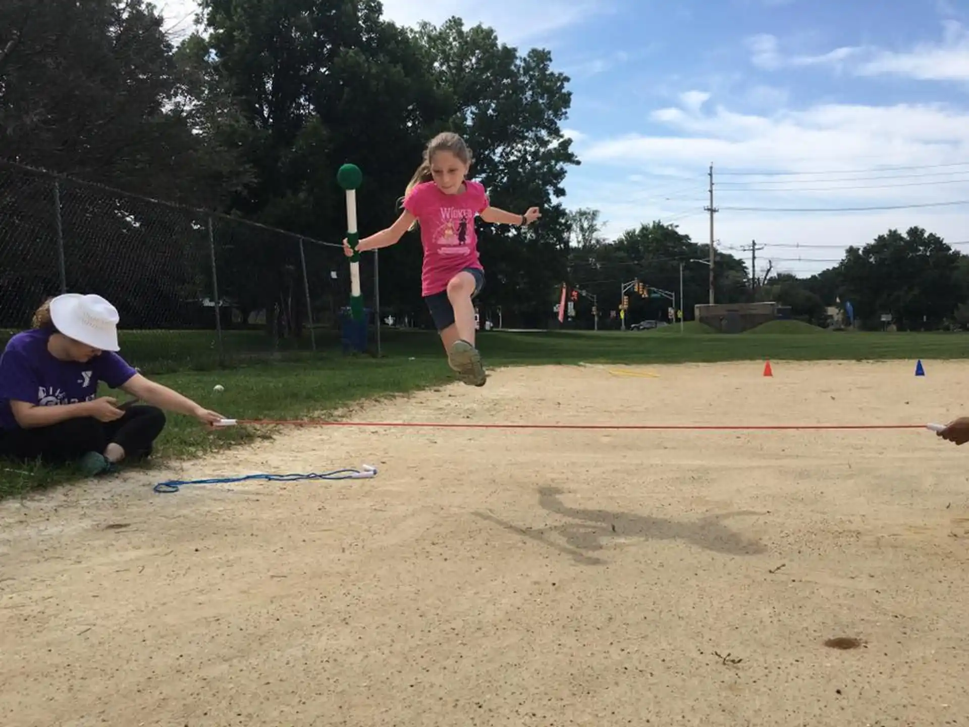 a girl jumping in the air with a ball in her hand
