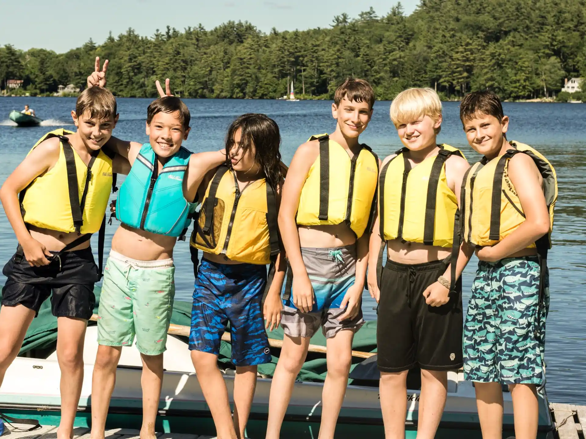 a group of people wearing life vests posing for a photo