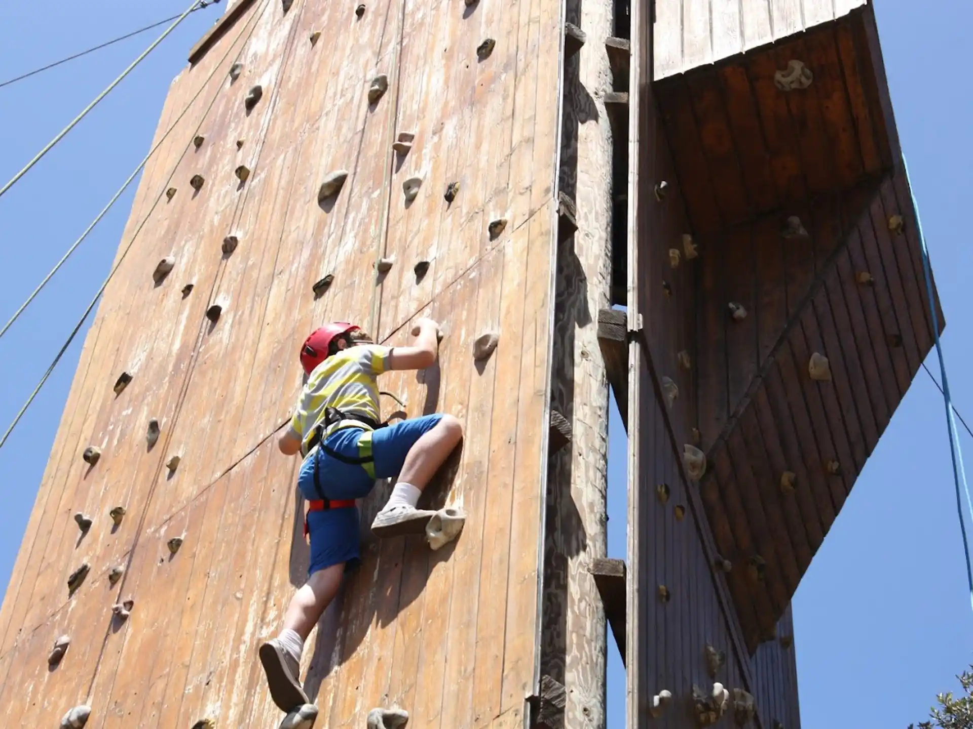a man climbing a tall wooden bridge
