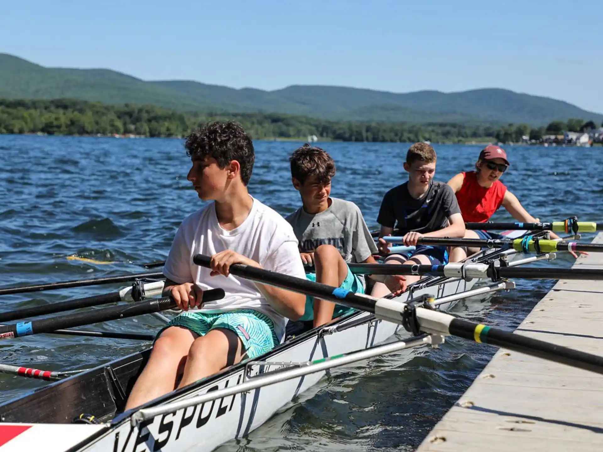 a group of people rowing a boat
