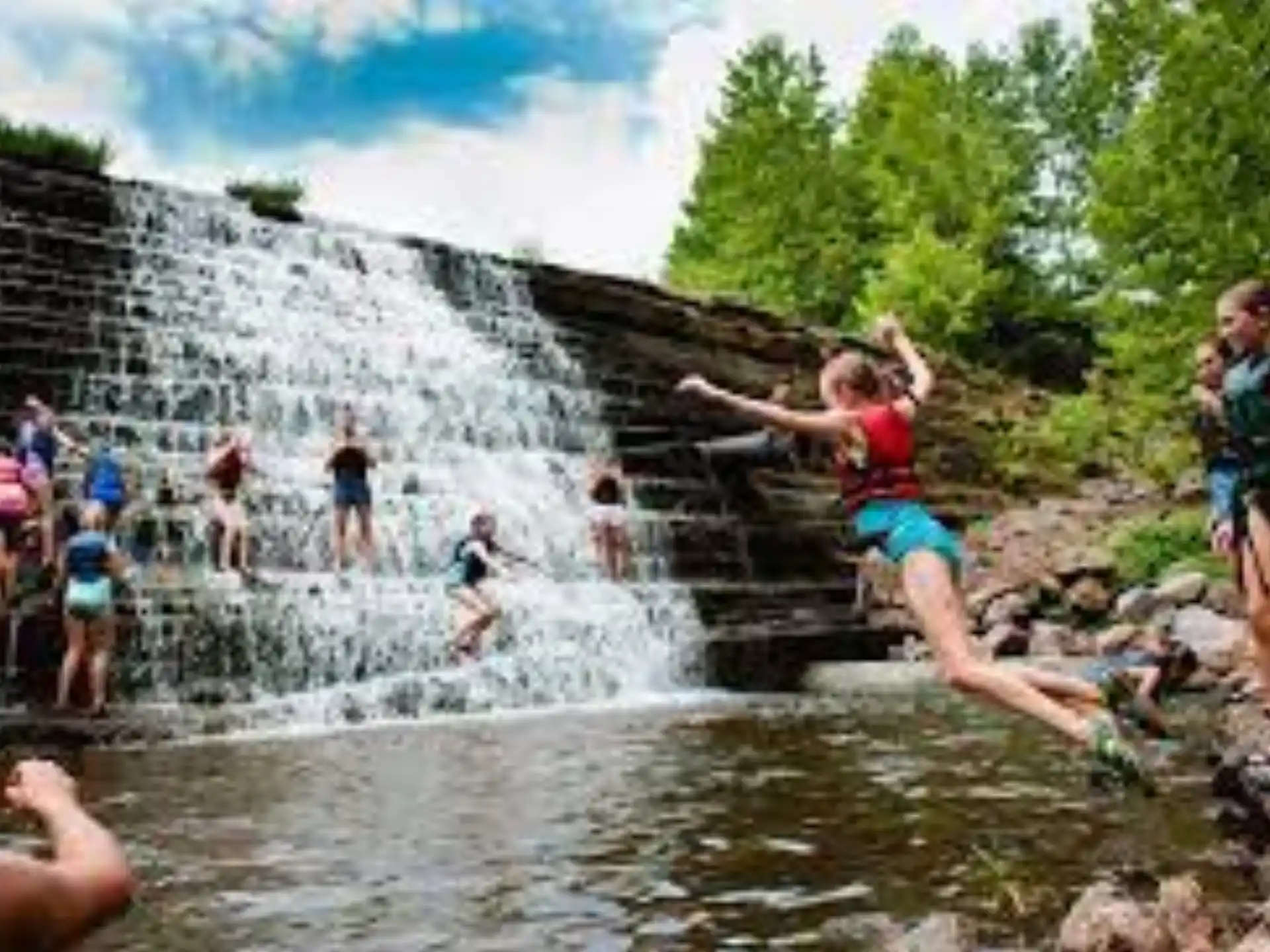 a group of people playing in a water fountain