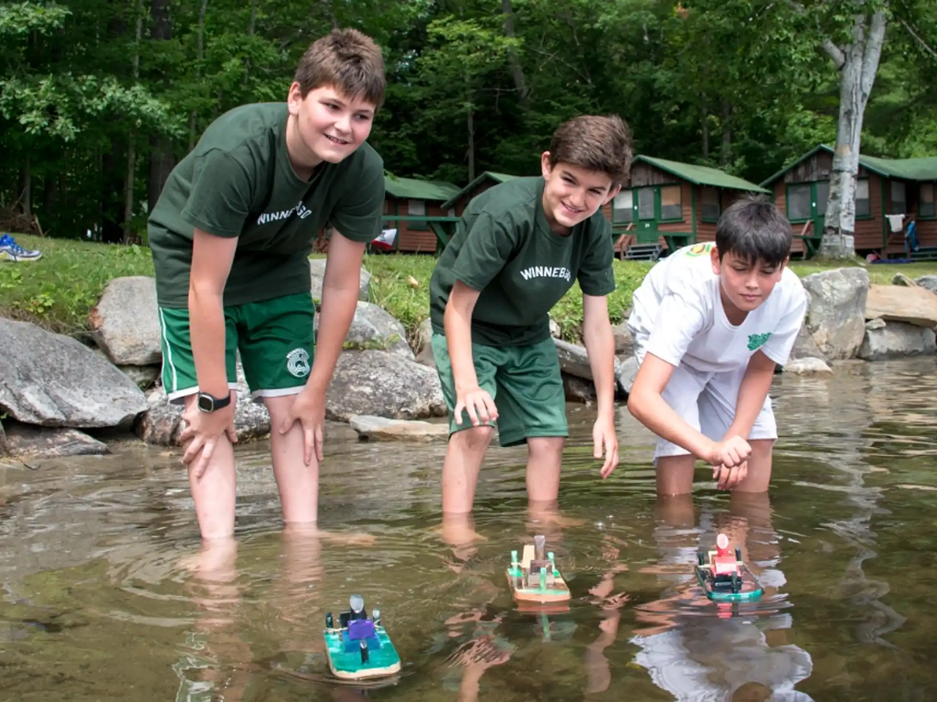 a group of boys playing in a pond