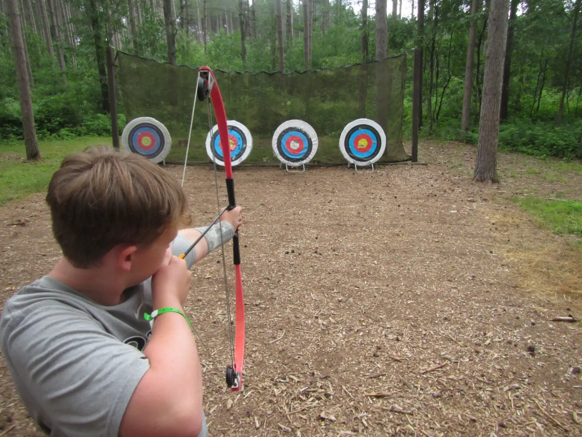 a boy shooting a bow and arrow