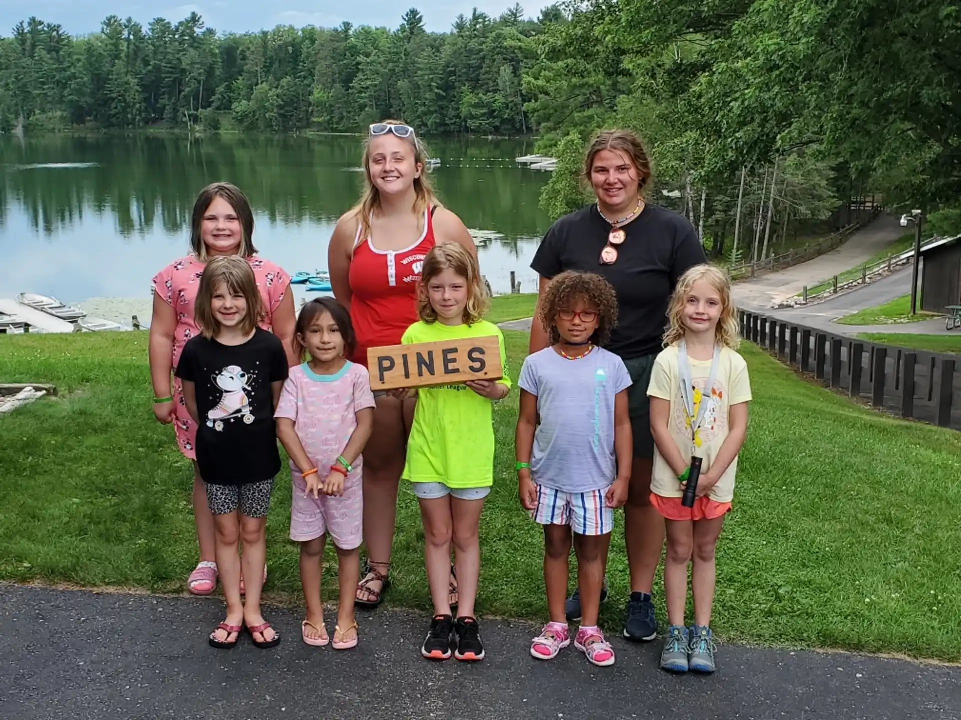 a group of people posing for a photo with a sign