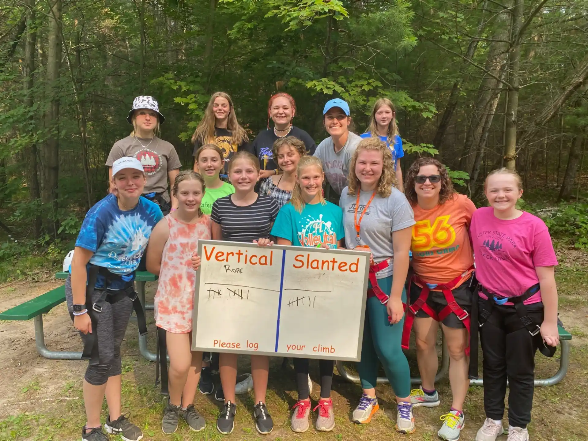 a group of people posing for a photo with a sign