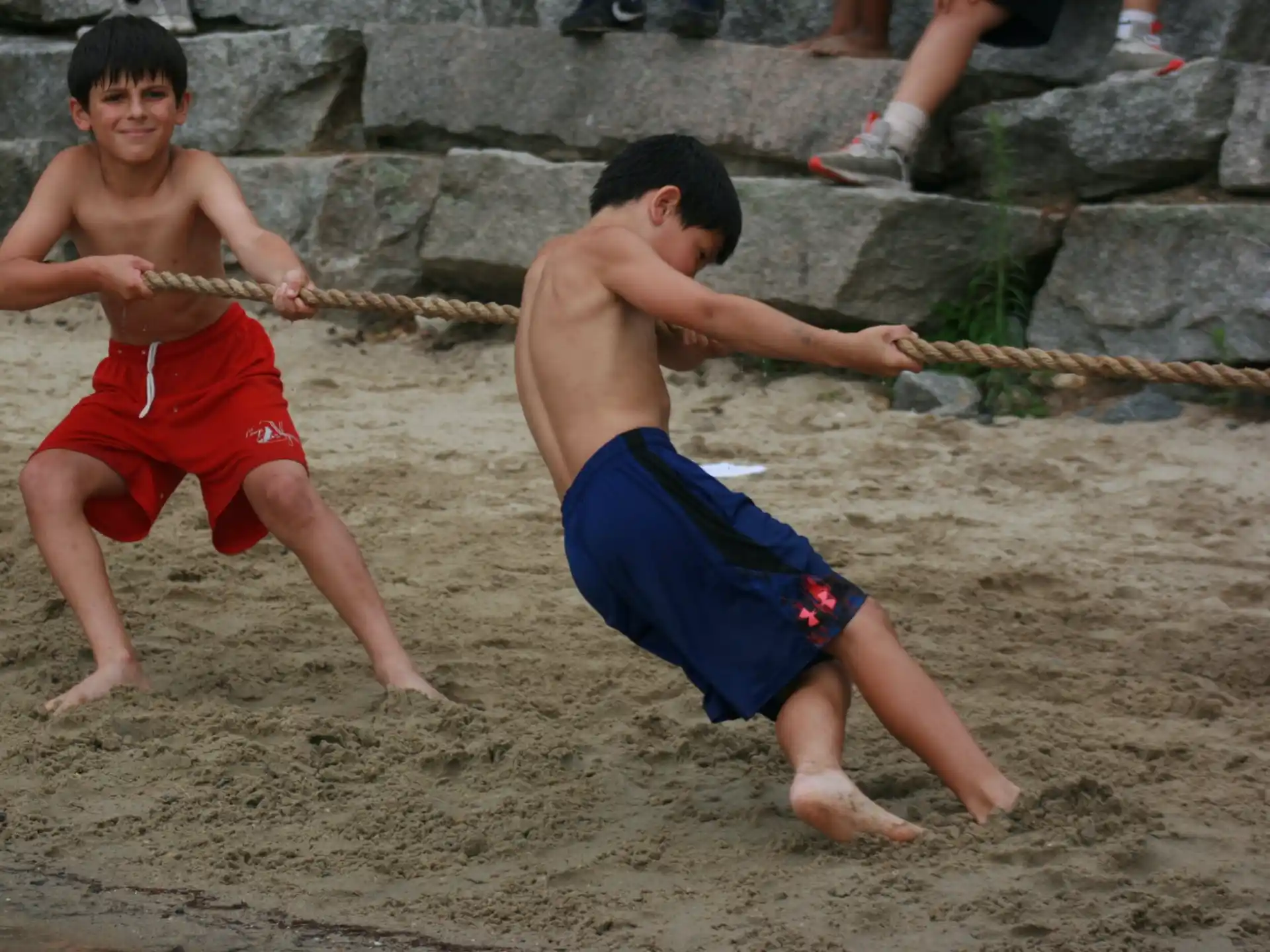 two boys playing with sticks