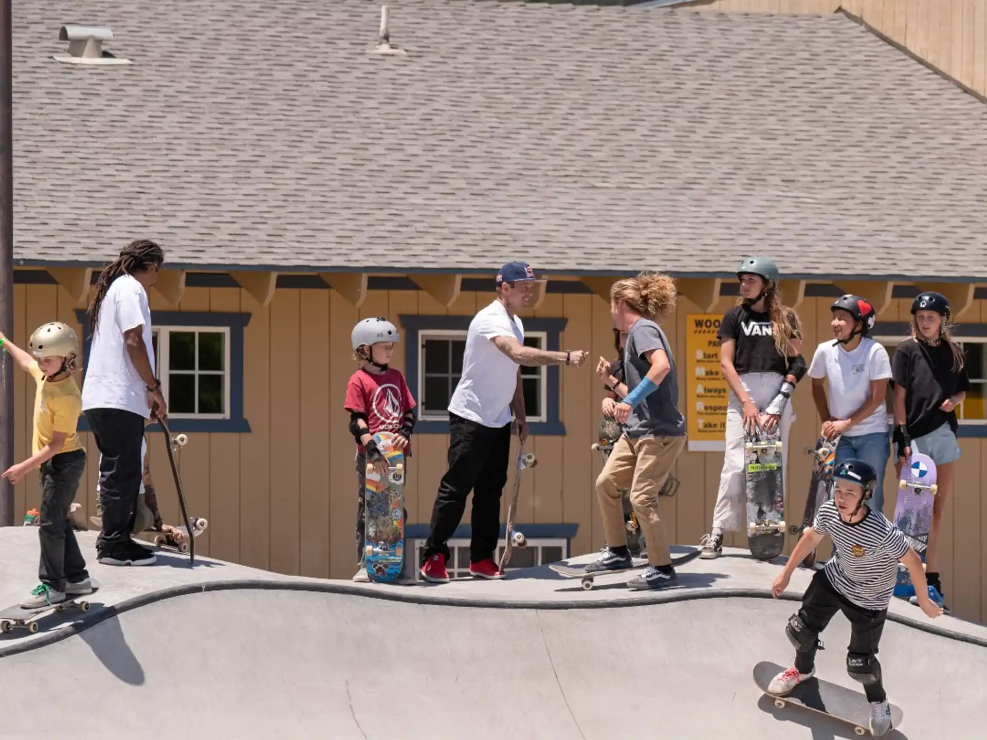 a group of people watching a man do a skateboard trick