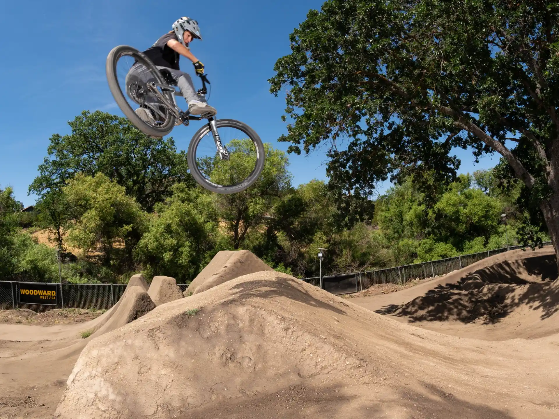 a man riding a bike over a ramp