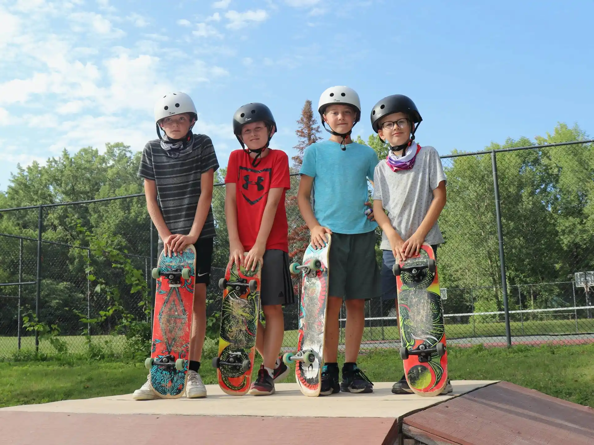 a group of kids holding skateboards