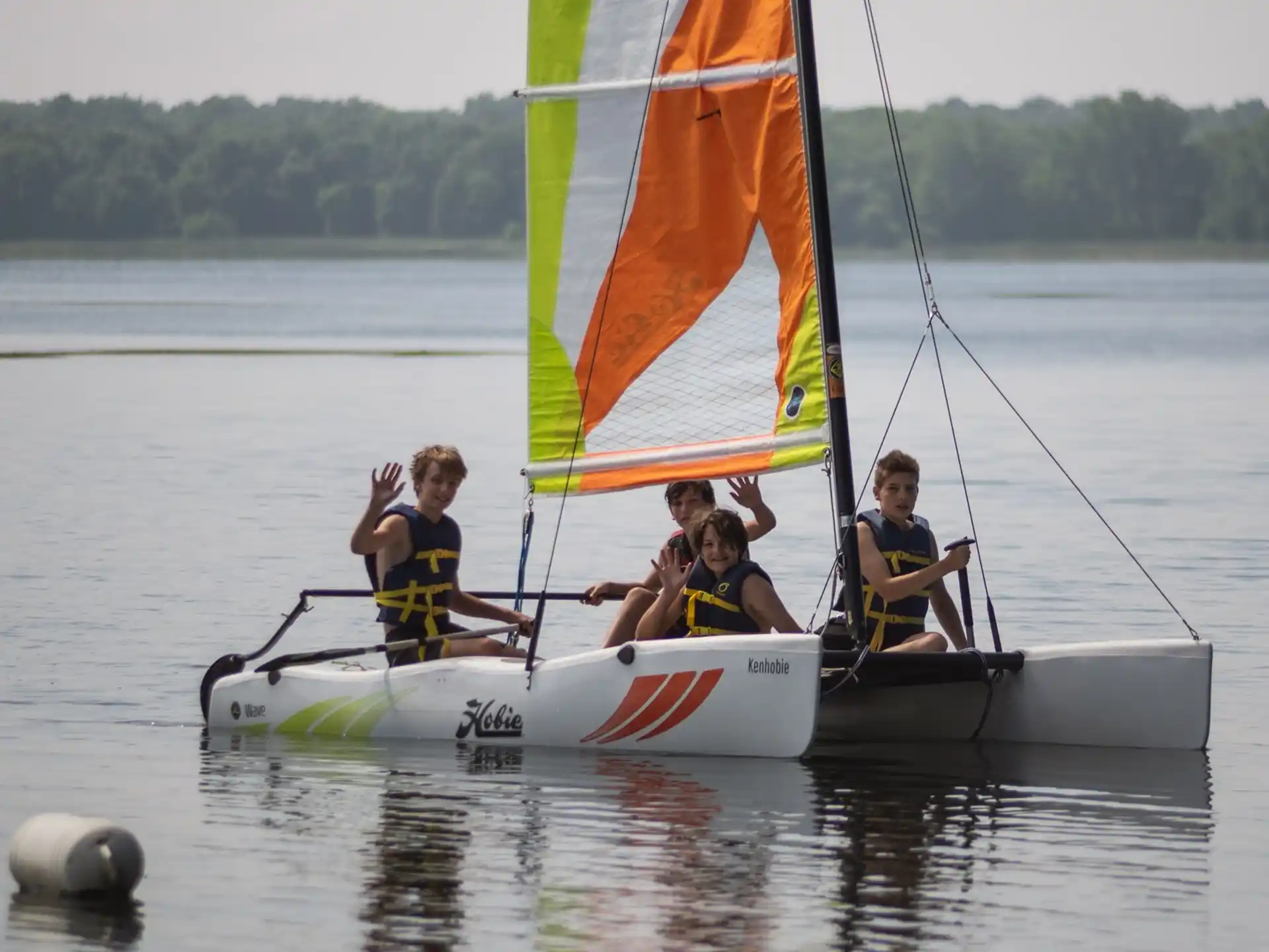 a group of people on a sailboat on water